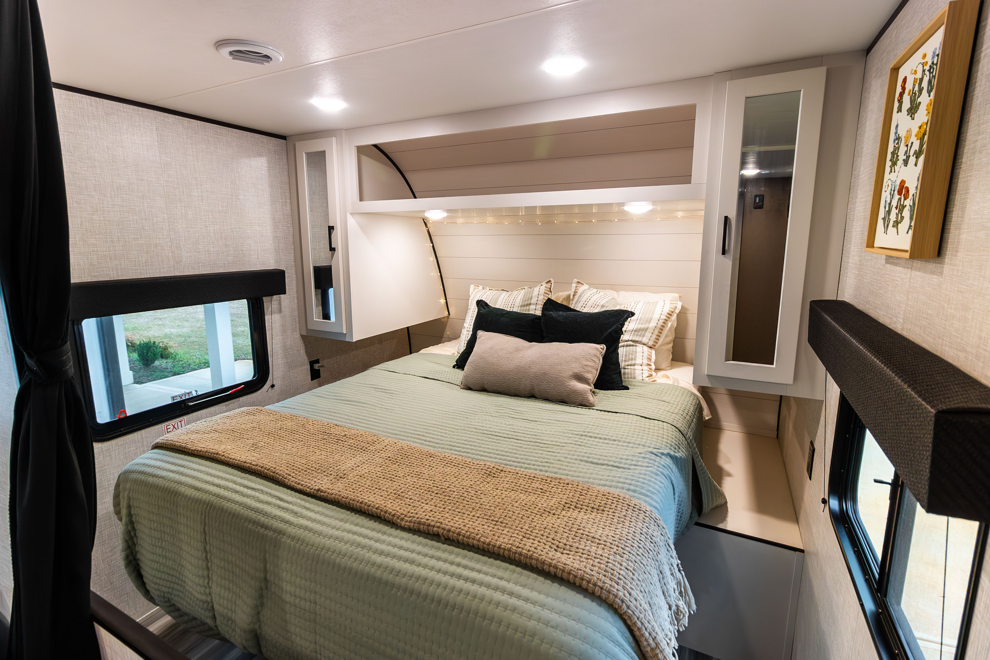 Cozy RV rental bedroom features a comfy bed, overhead storage, and natural light, perfect for your next adventure.. Jayco Jay Flight SLX 2024