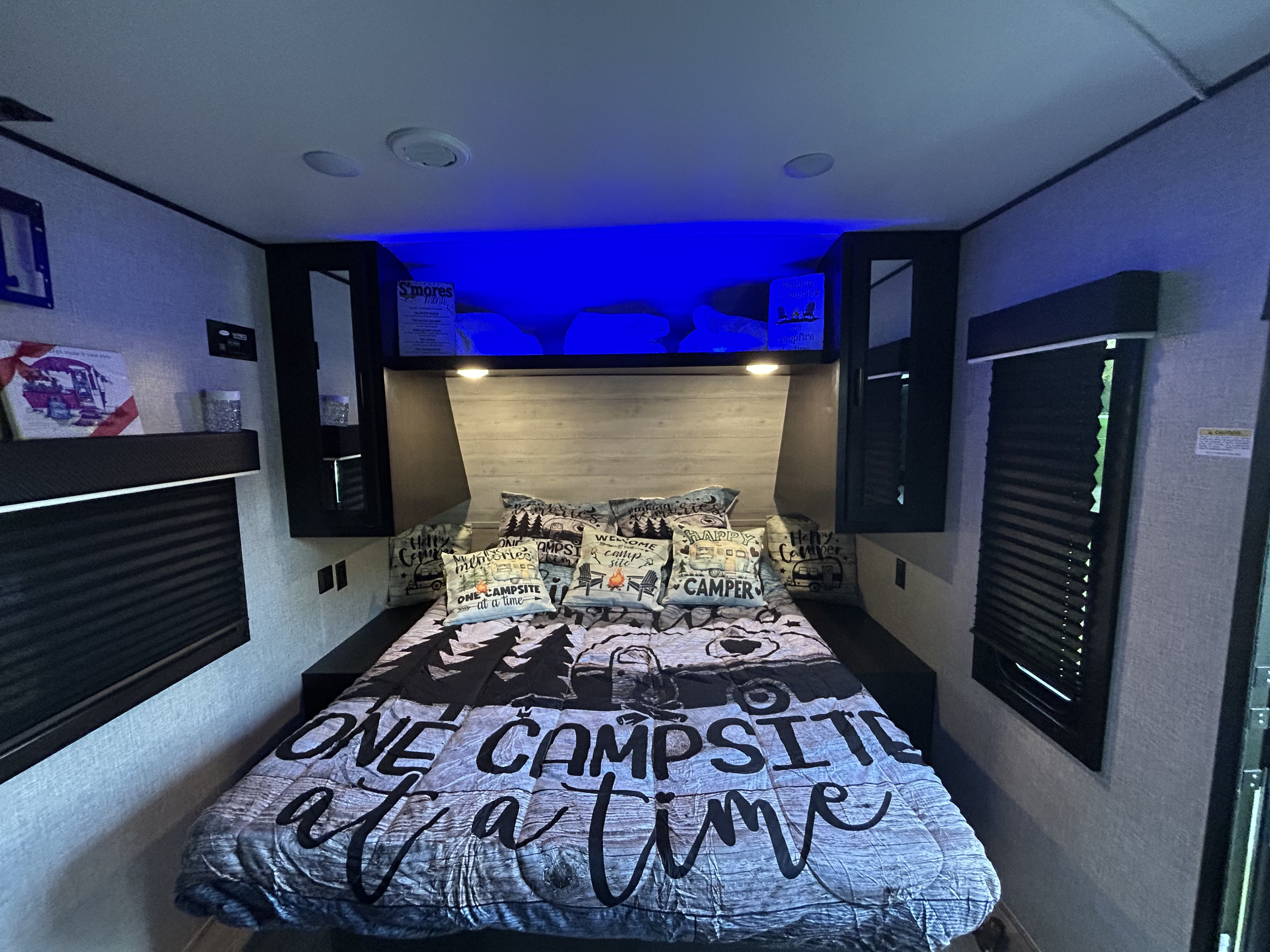 Cozy RV rental bedroom with camping decor and blue lights, perfect for your next adventure. Short queen bed . Jayco Jay Flight SLX 2022