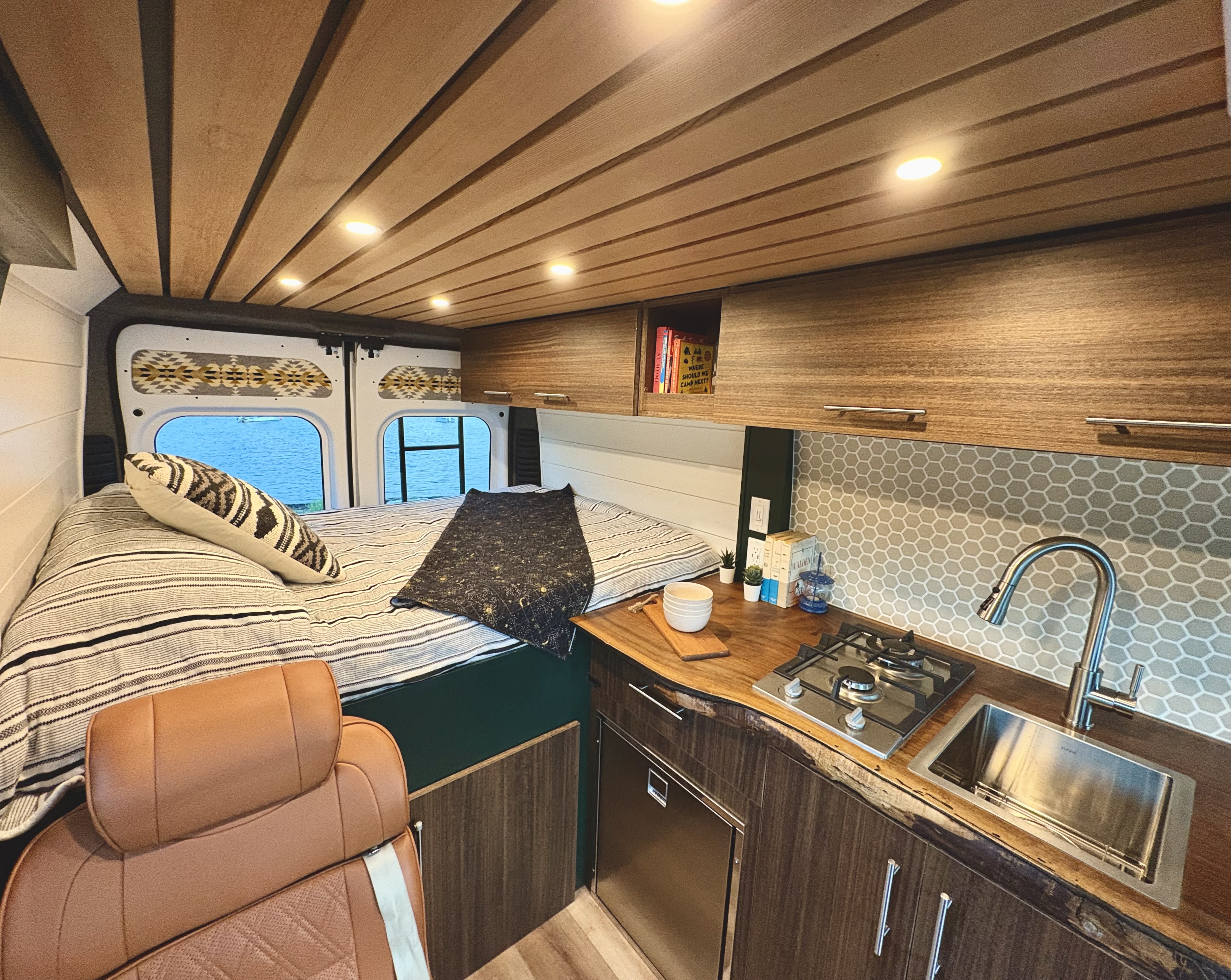 Experience this custom rv rental: features a cozy bed, compact kitchen with wood counters, and lake views.. Dodge Ram Promaster 2500 2020