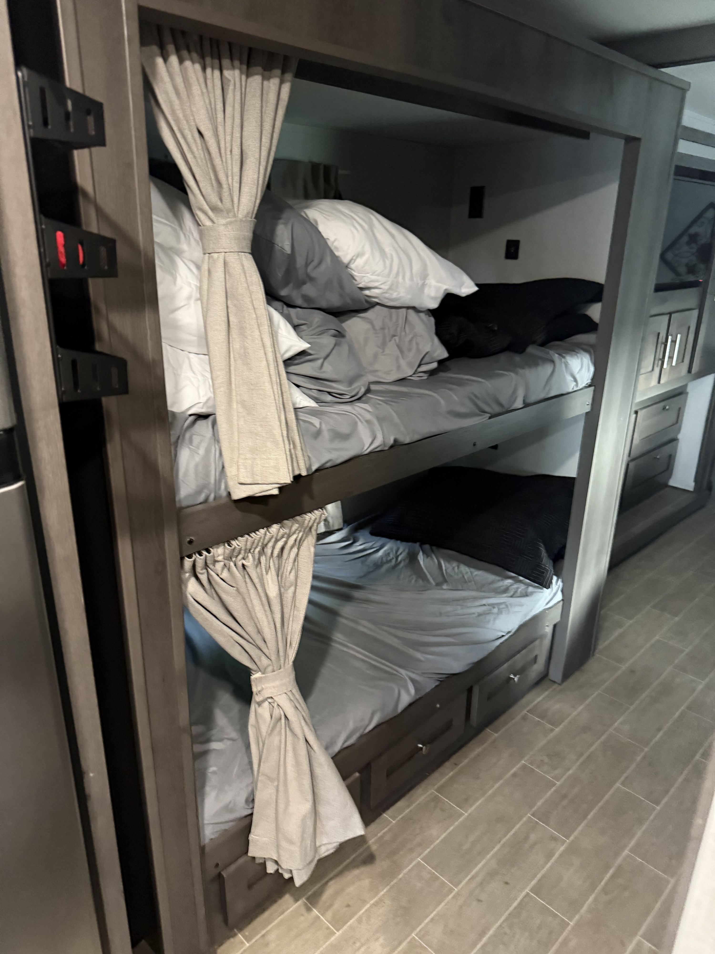 Inside an RV rental: Cozy bunk beds with privacy curtains and built-in storage drawers.. Georgetown GT5 2021
