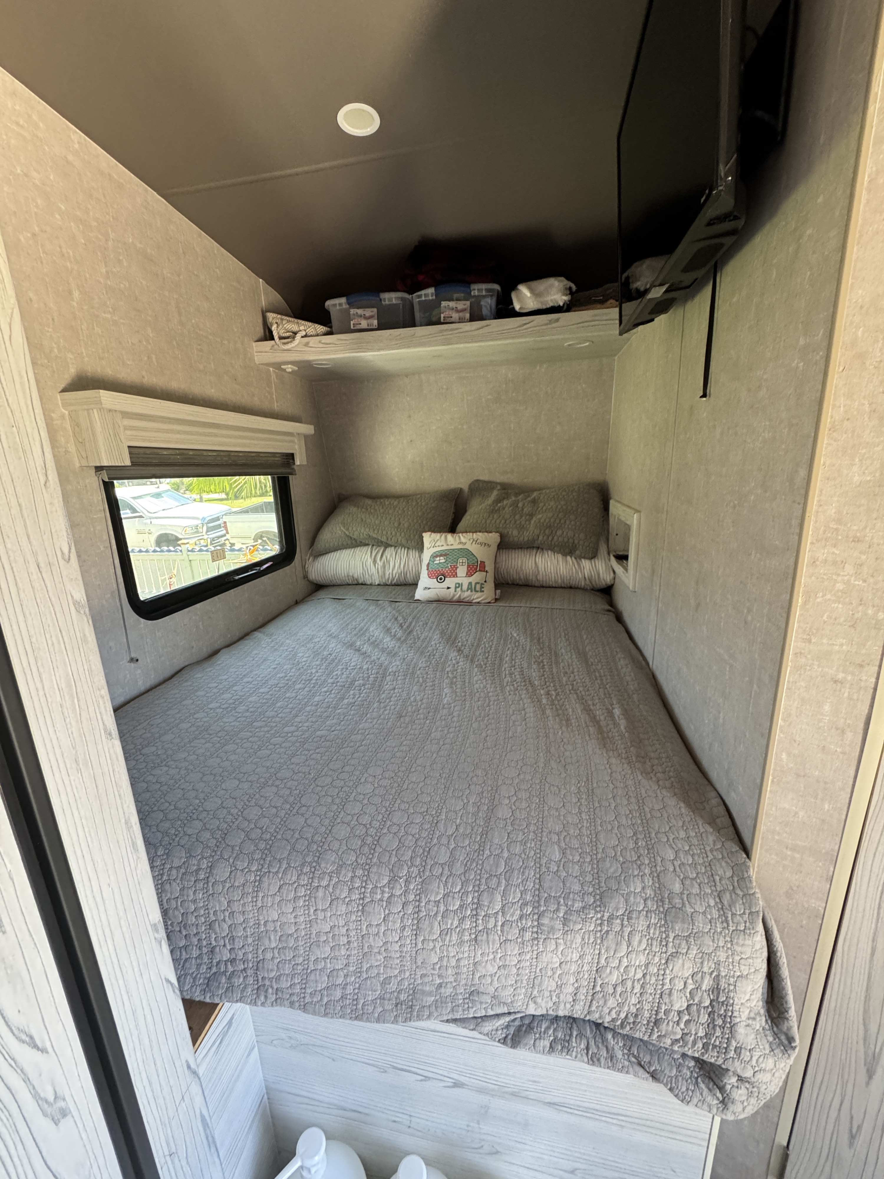 Cozy RV rental bedroom with a large bed, window, and TV. Ideal for comfortable travel.. Eclipse Recreational Vehicles Iconic 2022