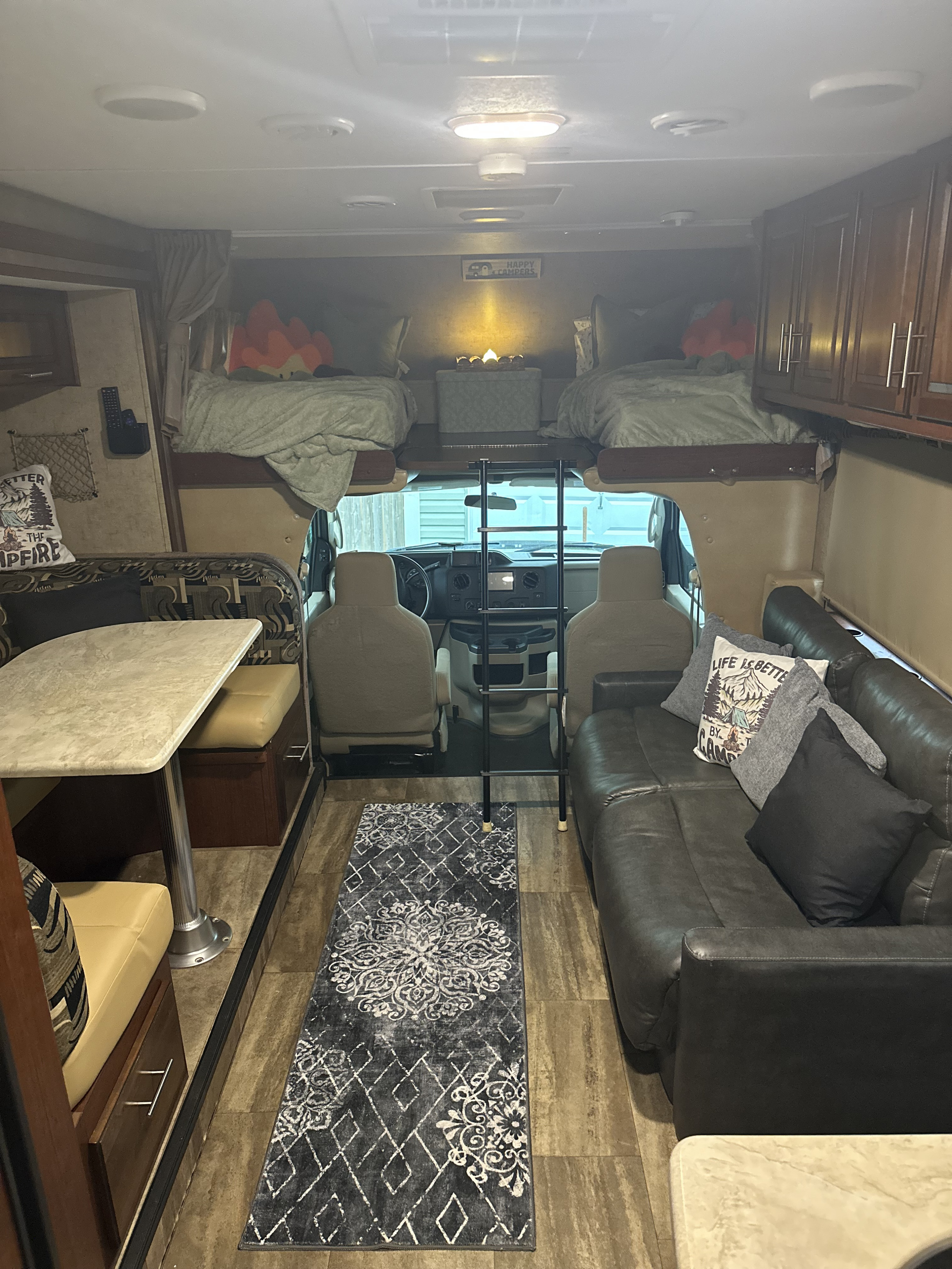 Spacious RV rental interior with dining, living, and bunk areas. Perfect for family adventures.. Forest River Sunseeker 2016