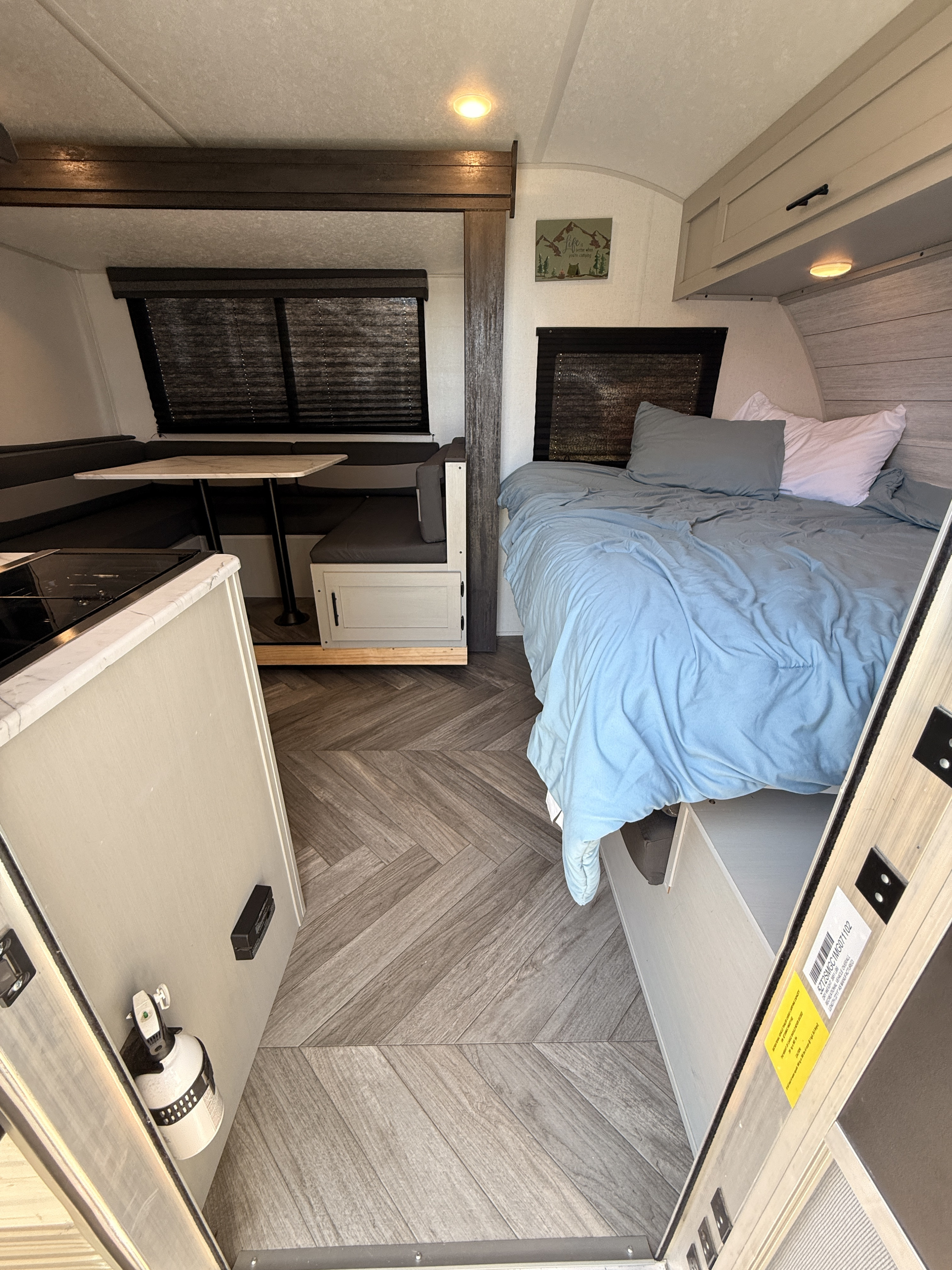 Spacious RV rental interior with a cozy bed, dinette, and kitchen. Perfect for your next camping adventure!. Forest River Salem FSX 2021