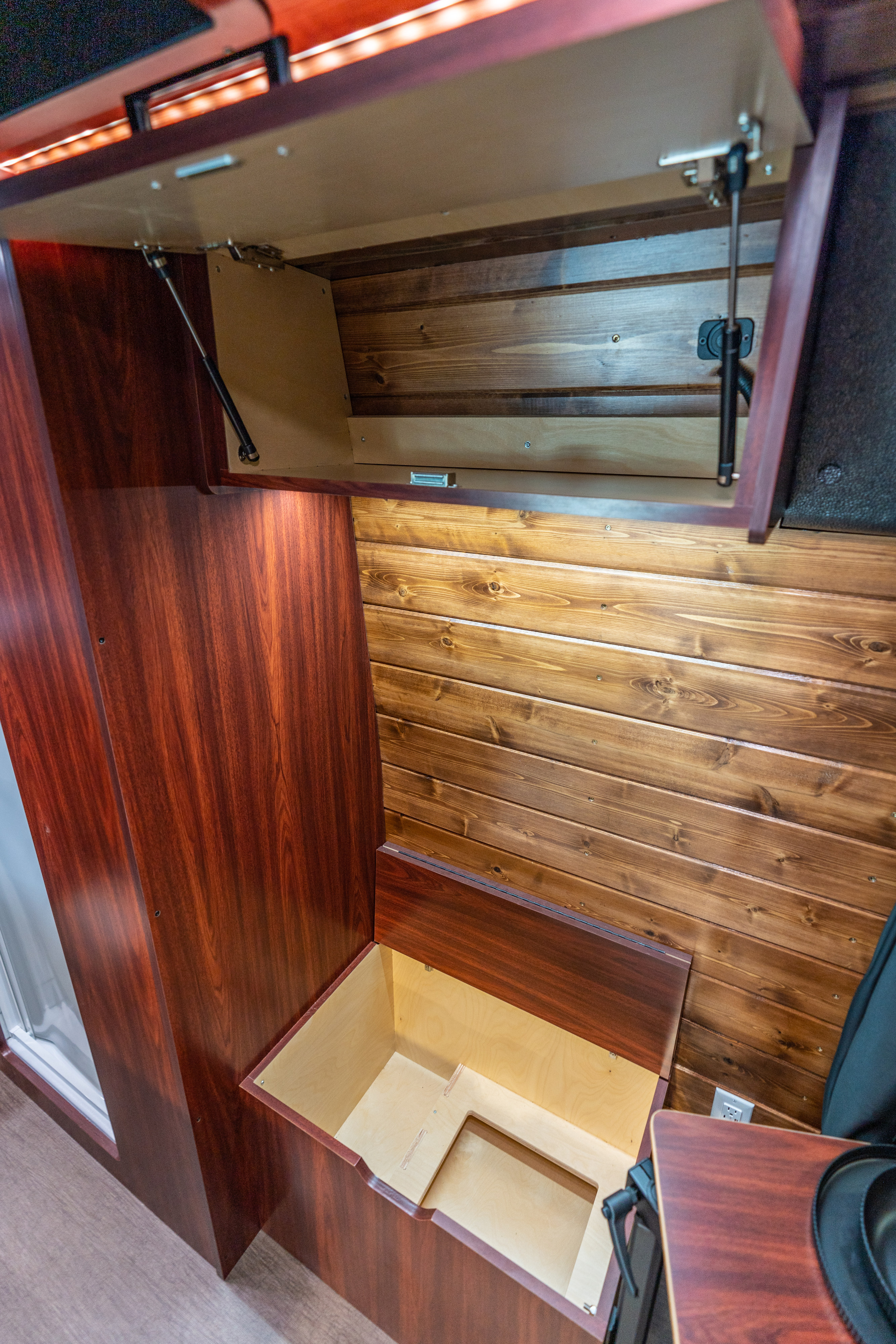 RV rental: interior with open overhead wood cabinet, gas struts, and a large storage compartment.. Mercedes-Benz Sprinter 2025