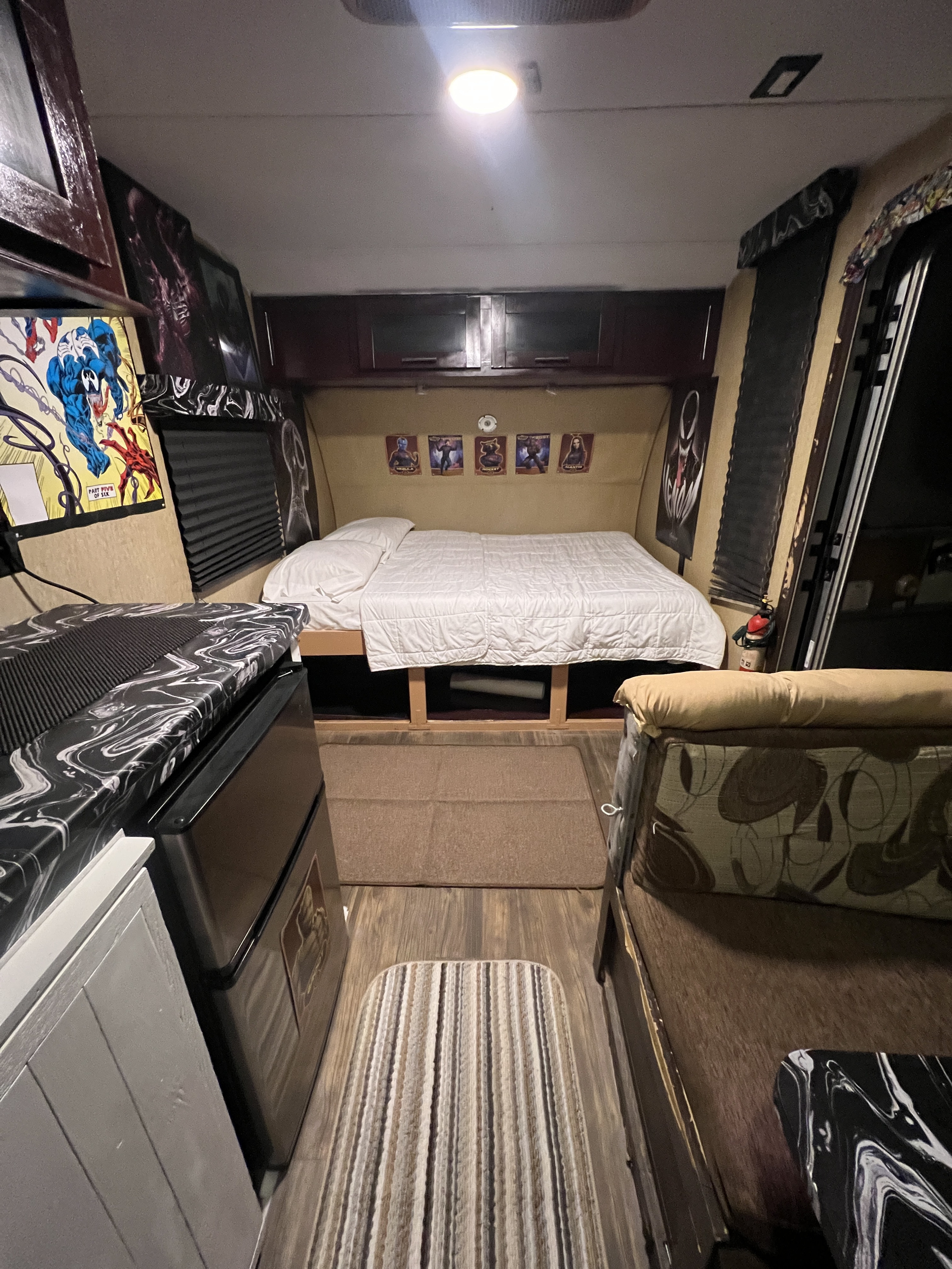 Inside a compact **rv rental** featuring a comfortable bed, functional kitchen area, and cozy living space.. Forest River Cherokee Wolf Pup 2016