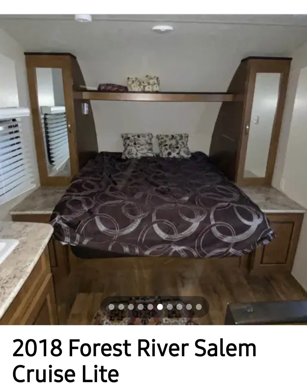 Cozy RV rental bedroom with a comfy bed, mirrored storage, and shelf. Perfect for your next adventure!. Forest River Salem Cruise Lite 2018