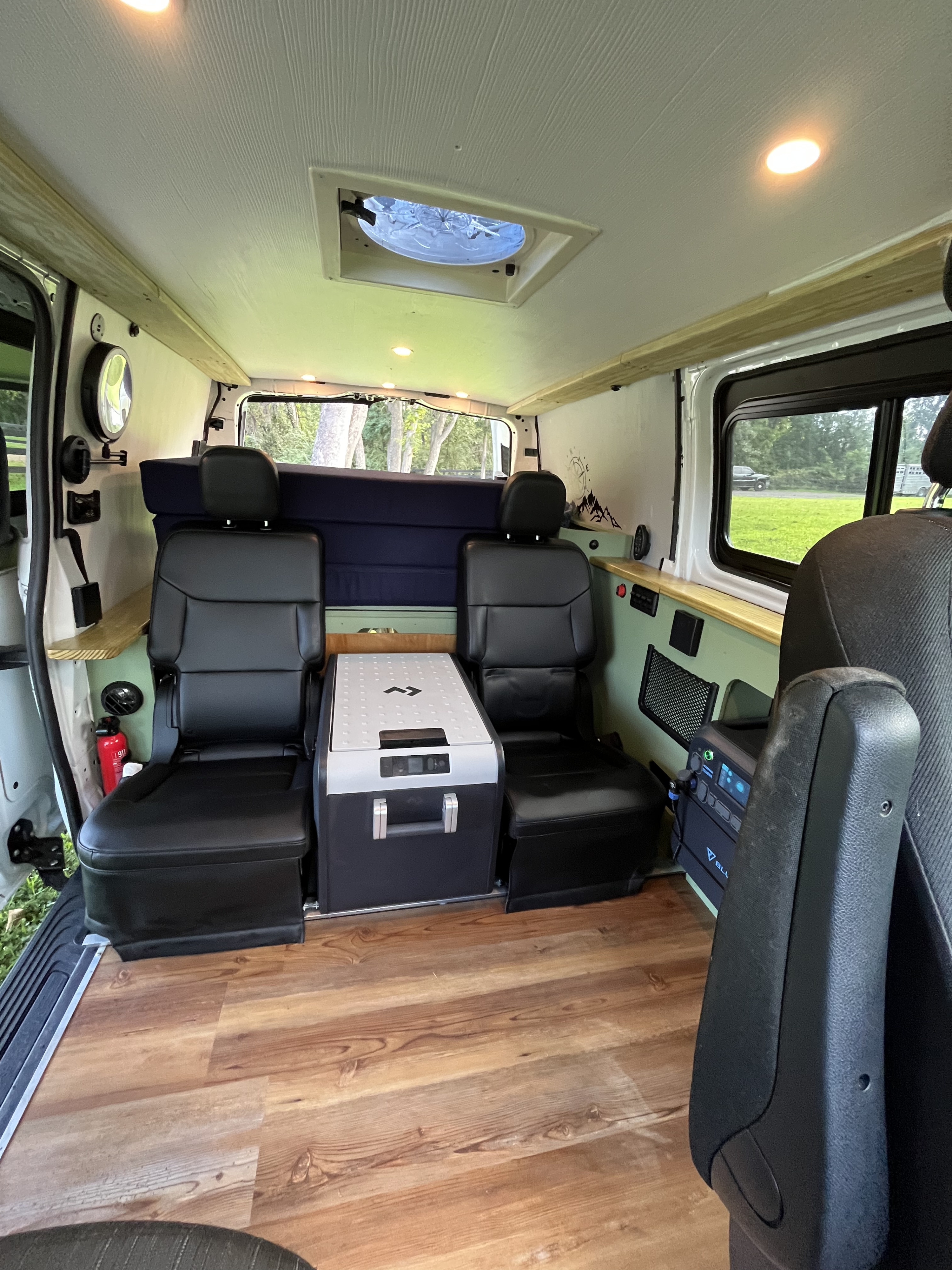 Inside an RV rental: features comfortable seating, portable refrigerator, and bed for your camper van adventures.. Homemade Mercedez Benz metris 2020
