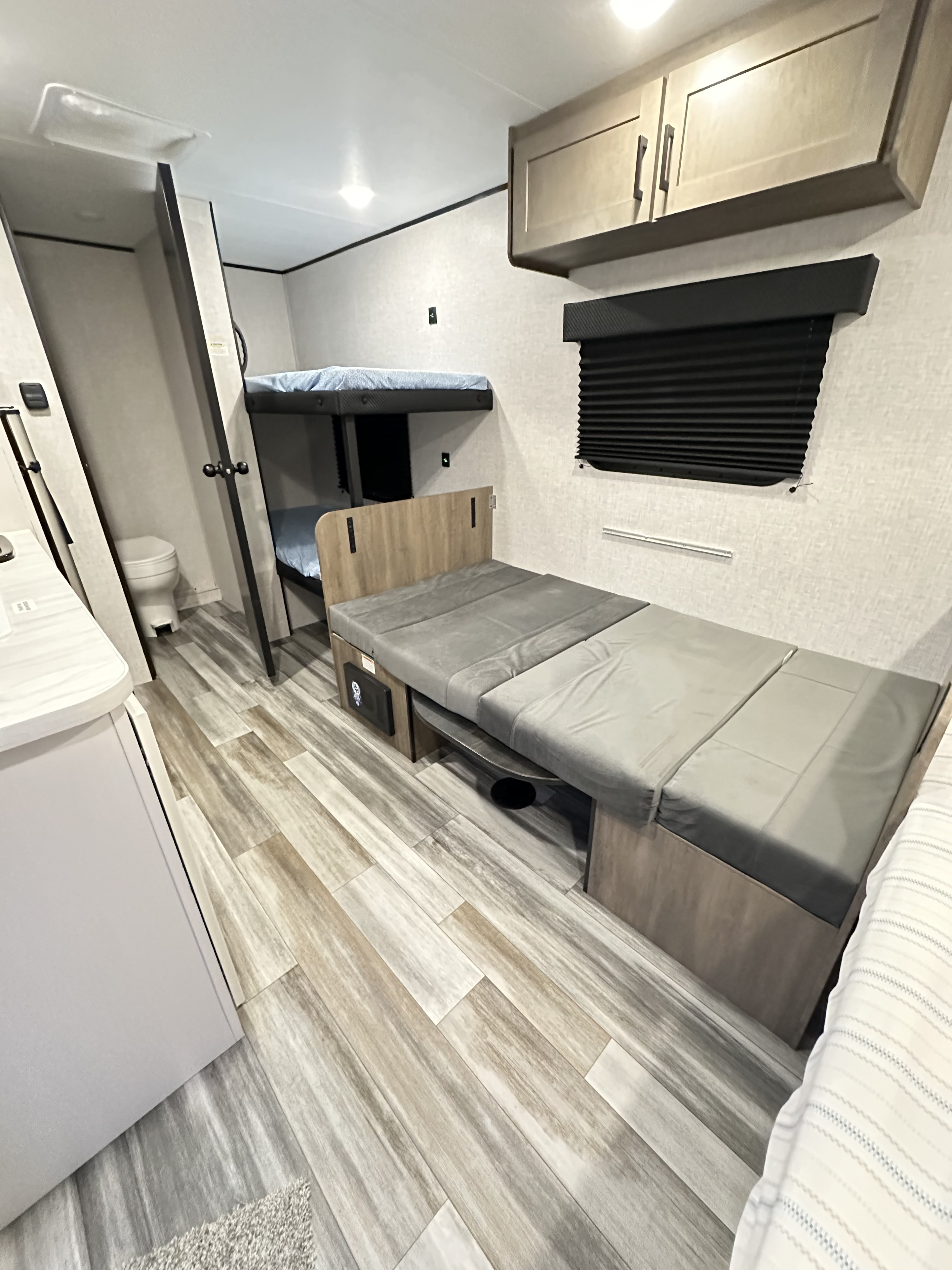 RV rental interior: Bunk beds, convertible sofa/bed, and discreet bathroom entrance for comfort.. Jayco Jay Flight SLX Sport Edition 2025