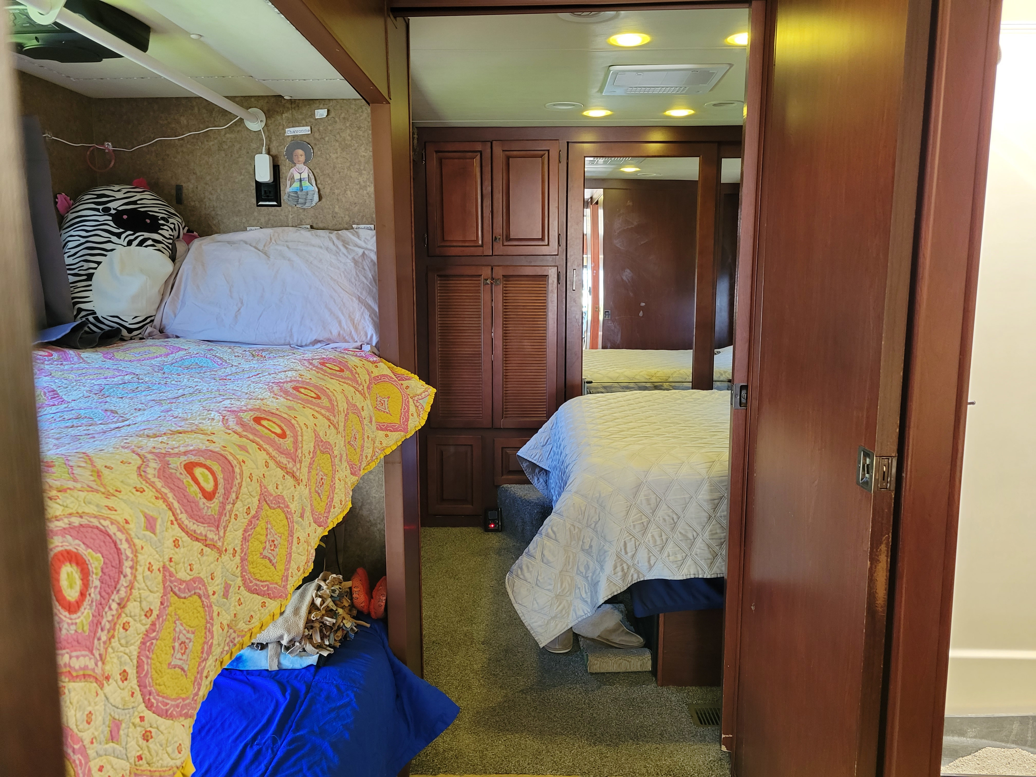 Explore this cozy RV rental interior: colorful bunk beds, a main bed, and ample storage, perfect for family adventures.. Forest River Berkshire 390-Bunkhouse 2012