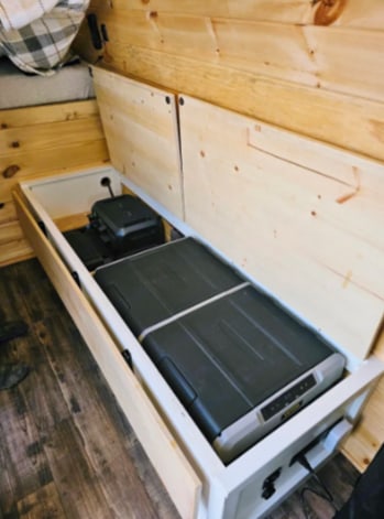 This RV rental interior features a pull-out portable fridge and power unit, ideal for camper van adventures and camping.. Spring Mercedes 2019