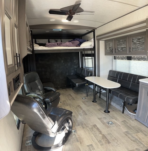 This spacious RV rental toy hauler features a loft bed, flexible seating, and a convertible garage for versatile adventures.. Heartland Fuel 287 2021