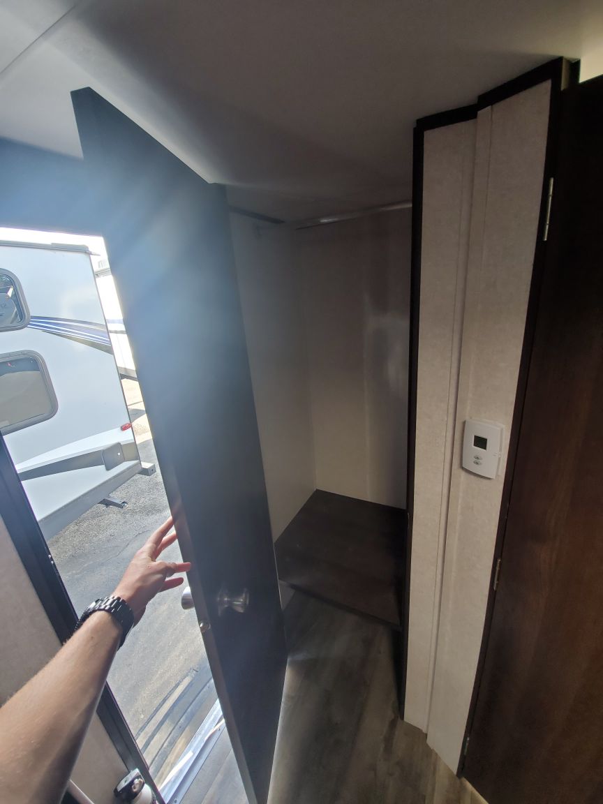 RV rental: Practical interior wardrobe with hanging rod and shelf, offering ample storage for your gear.. Jayco Jay Flight SLX Baja Edition 2019