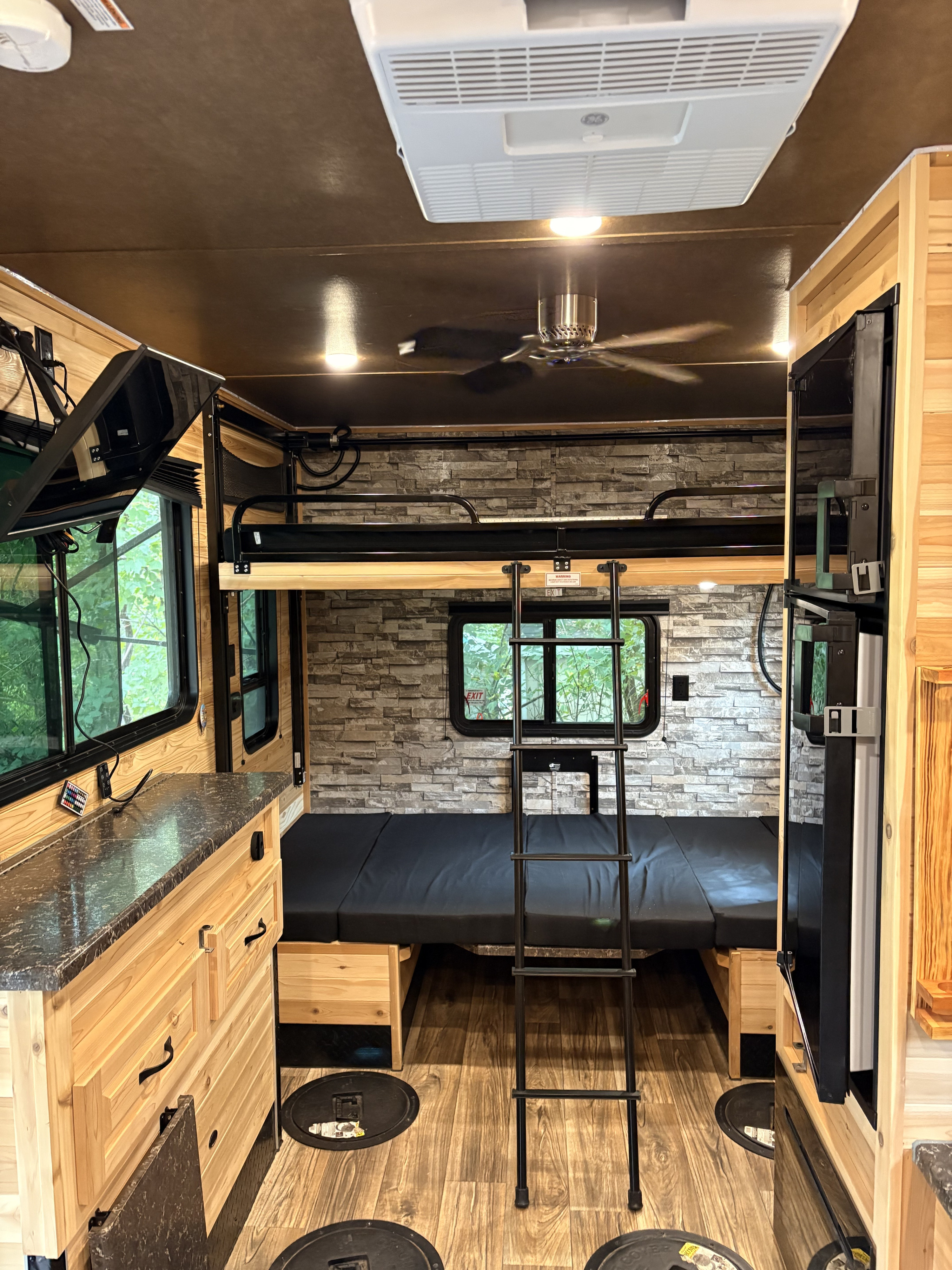 Inside an RV rental, this spacious ice house features bunk beds, a cozy living area, and amenities for winter adventures.. Glacier RV Explorer 17 RV Explorer 2024