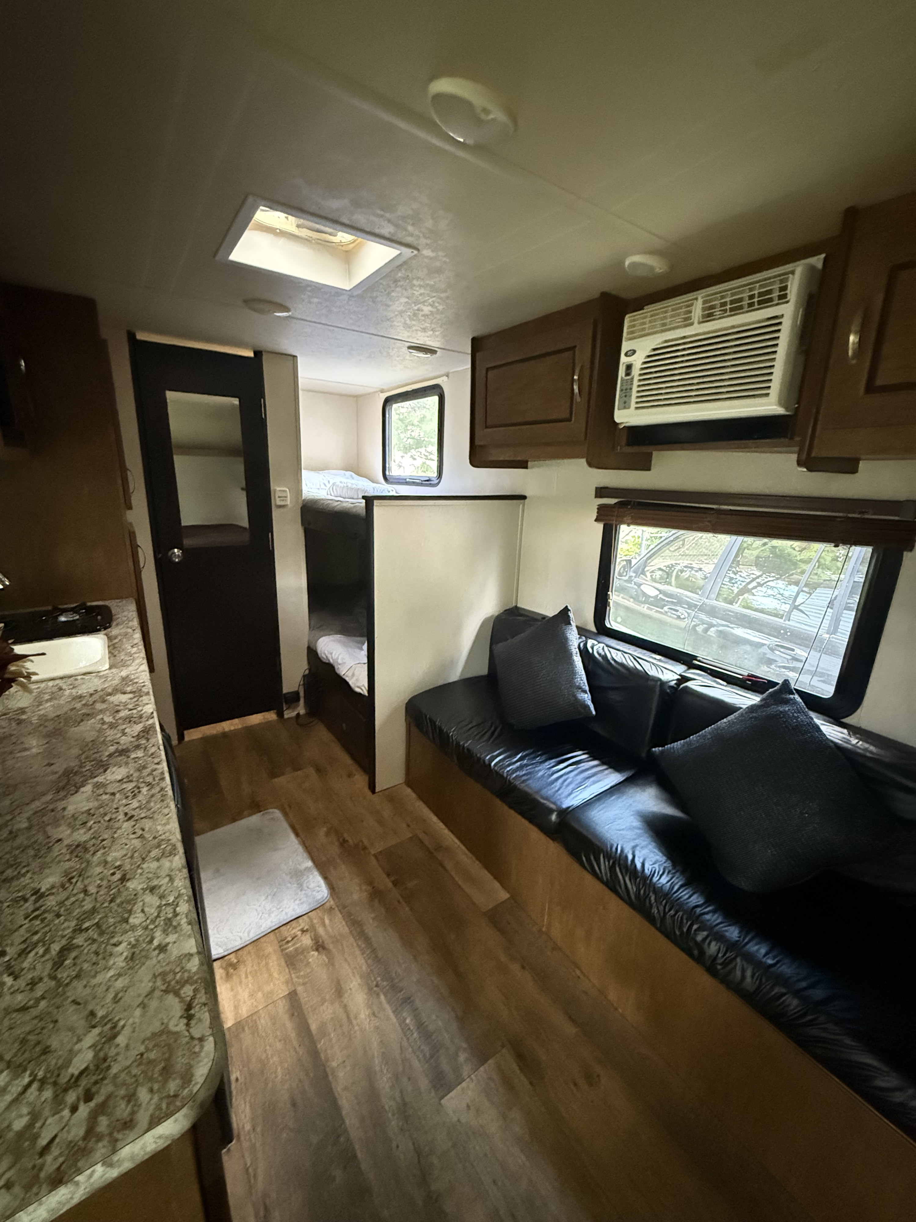Experience comfort in this RV rental featuring a living area with a couch, bunk beds, kitchen space, and AC.. Forest River Salem Cruise Lite 2019