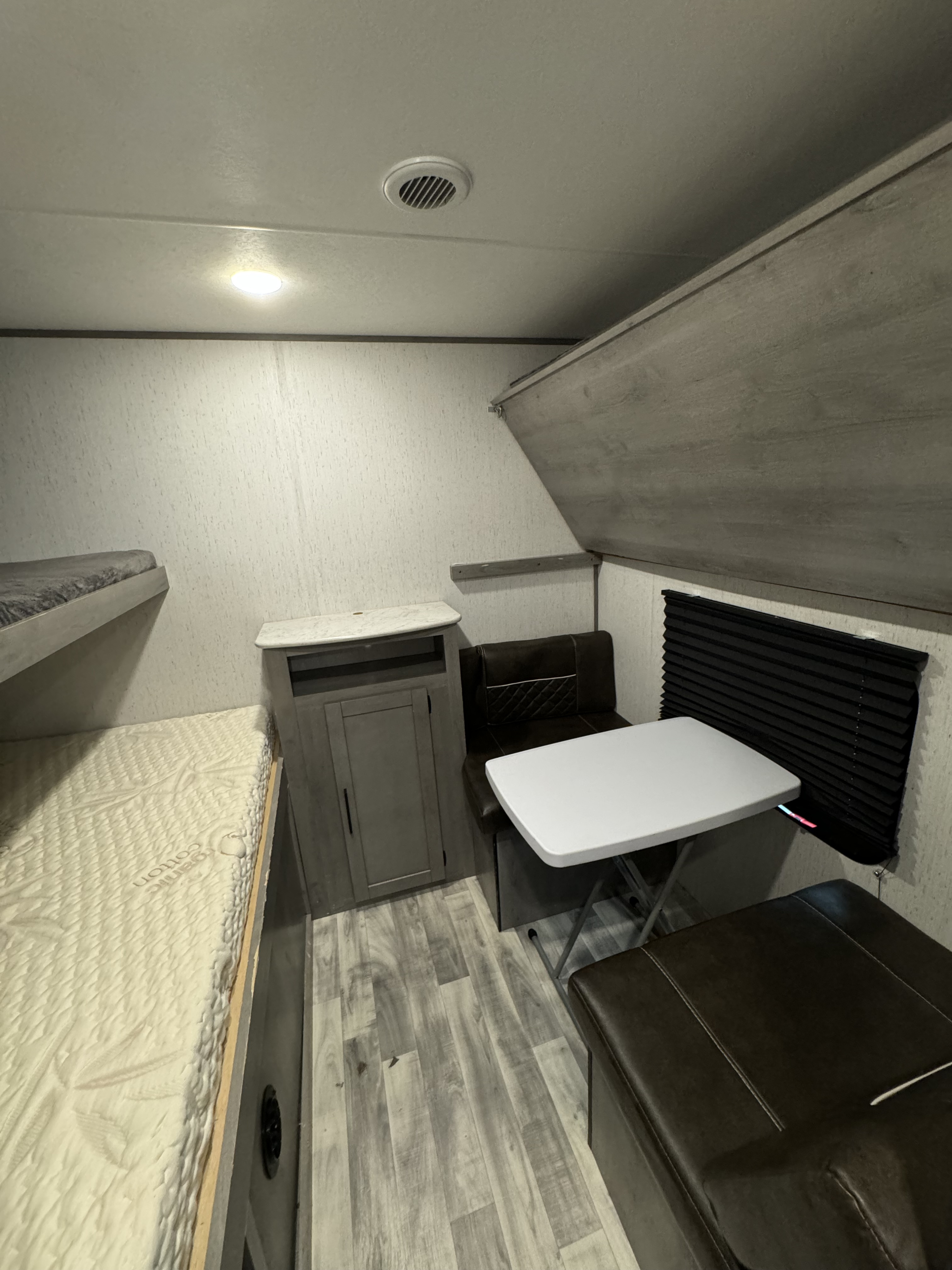 RV rental interior: featuring comfortable bunk beds, a functional dinette area with table, and convenient storage.. Dutchmen Kodiak 2021