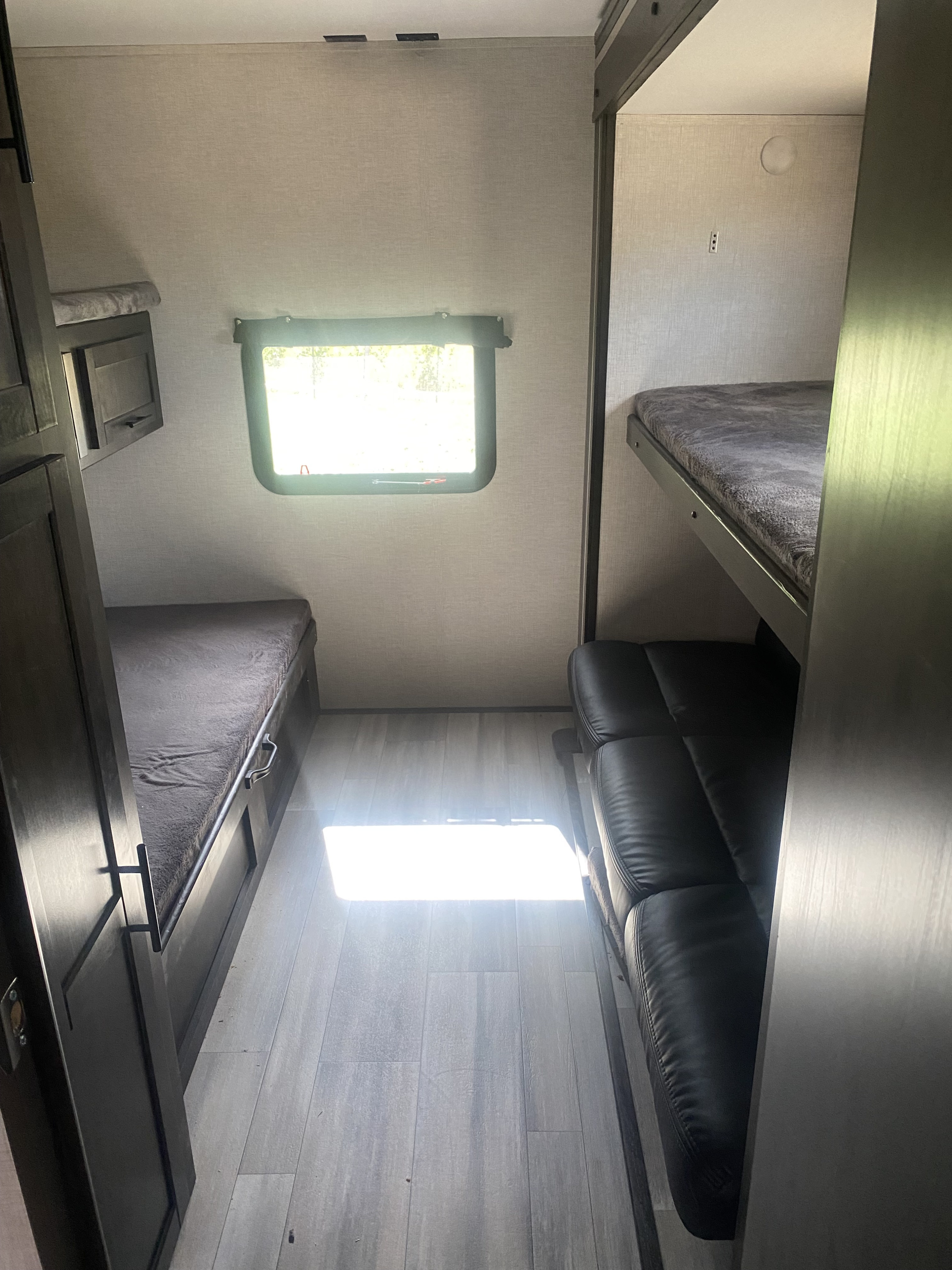 RV rental interior: Multiple bunk beds, sofa, and a bright window.. Crossroads RV Cruiser Aire 2021