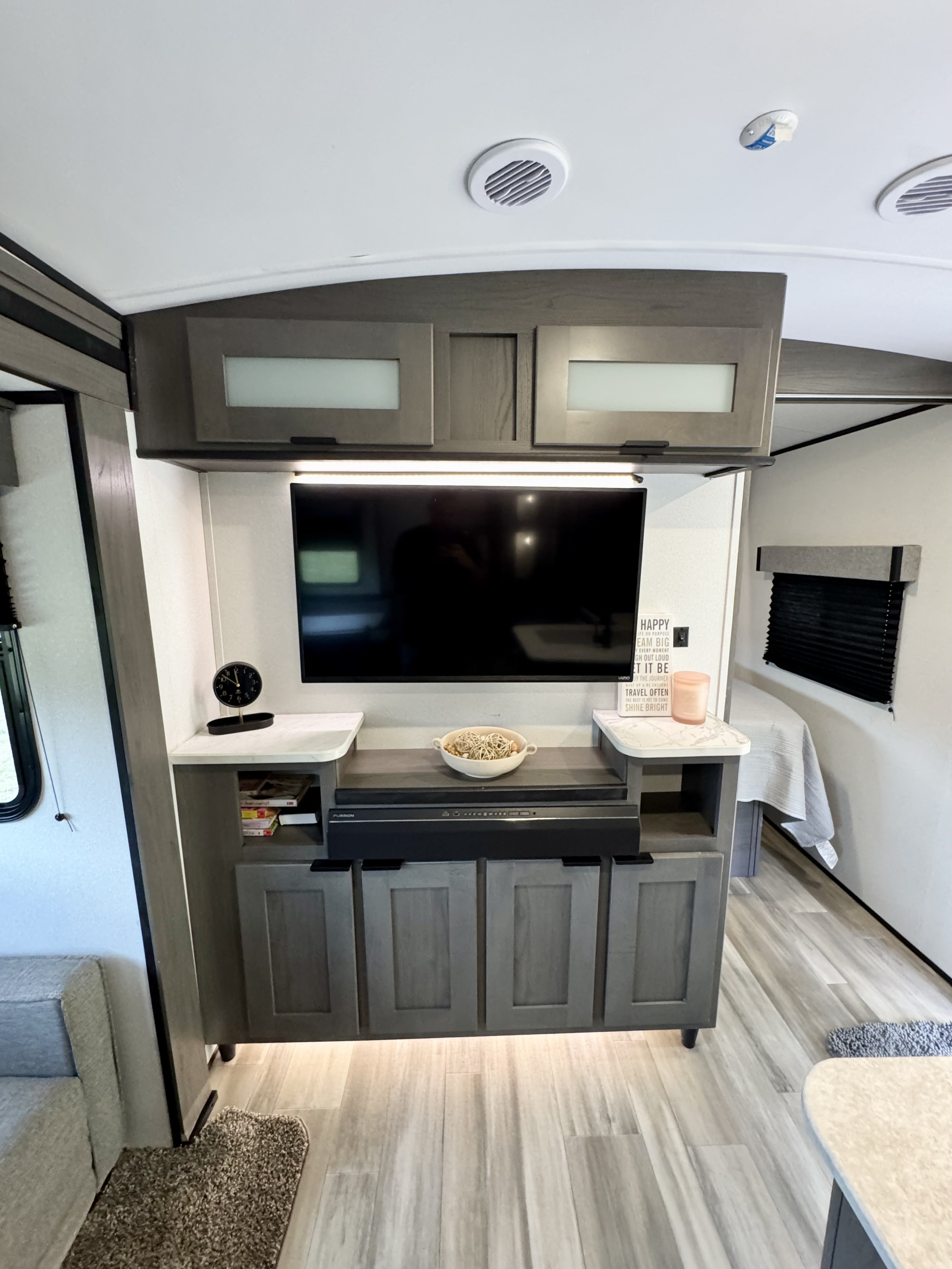 Modern RV rental interior: A well-appointed living space with TV, Furrion soundbar, and ample storage for comfortable travel.. Cruiser RV MPG Ultra Lite 2022