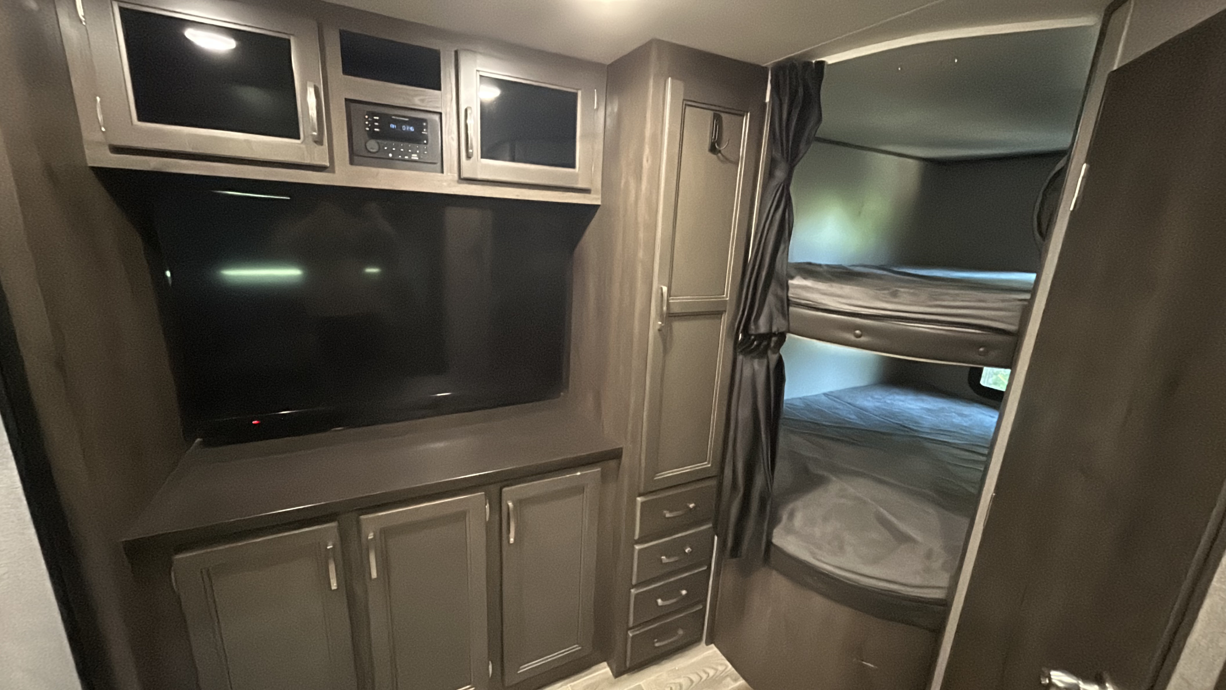 Step inside this RV rental, featuring a full entertainment center with TV and stereo, ample storage, and cozy bunk beds.. Jayco Jay Flight 2021