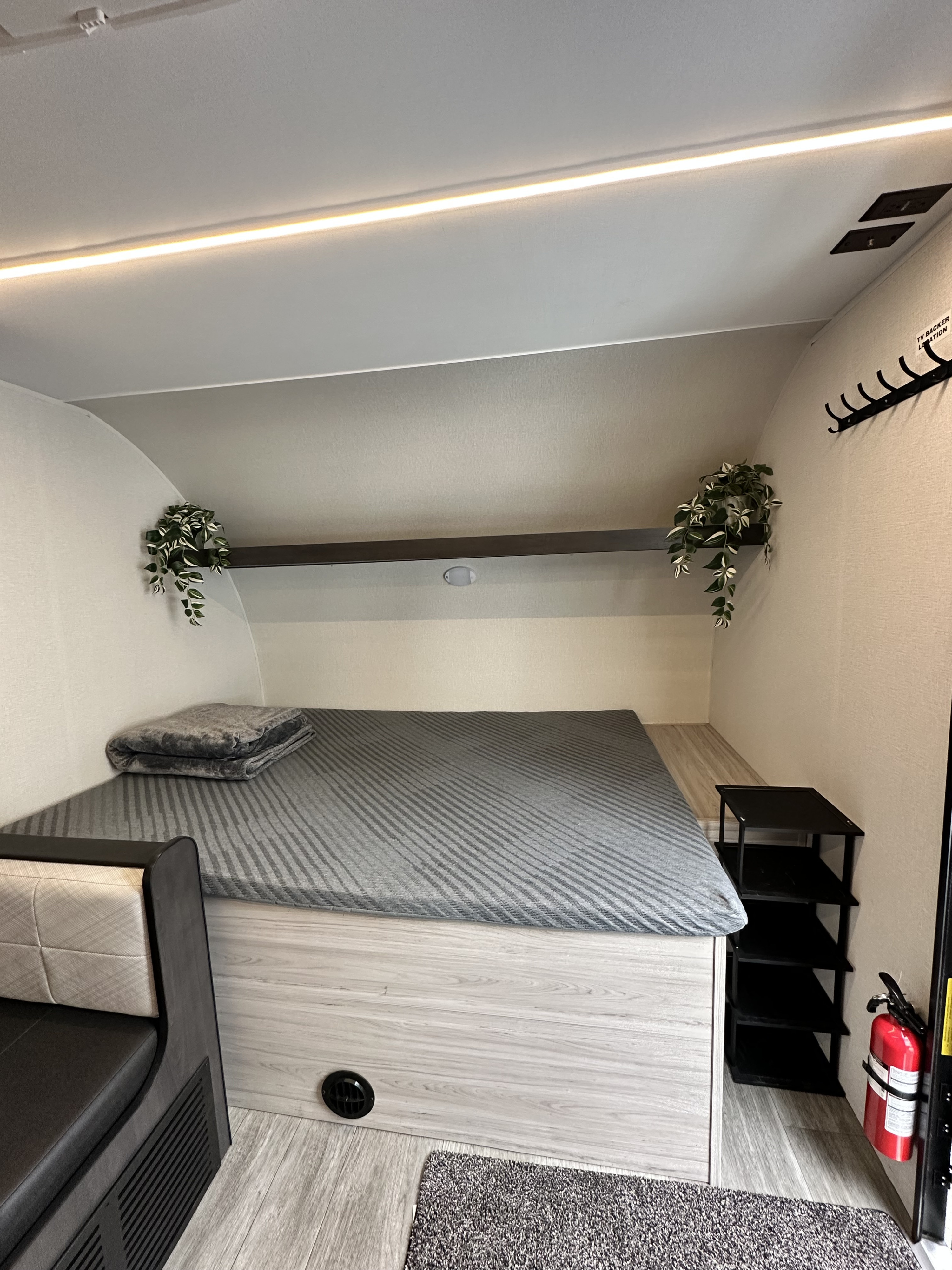 Modern RV rental interior with a comfy bed, LED lighting, and thoughtful details, creating a cozy and functional sleeping space.. Heartland Mallard 2025