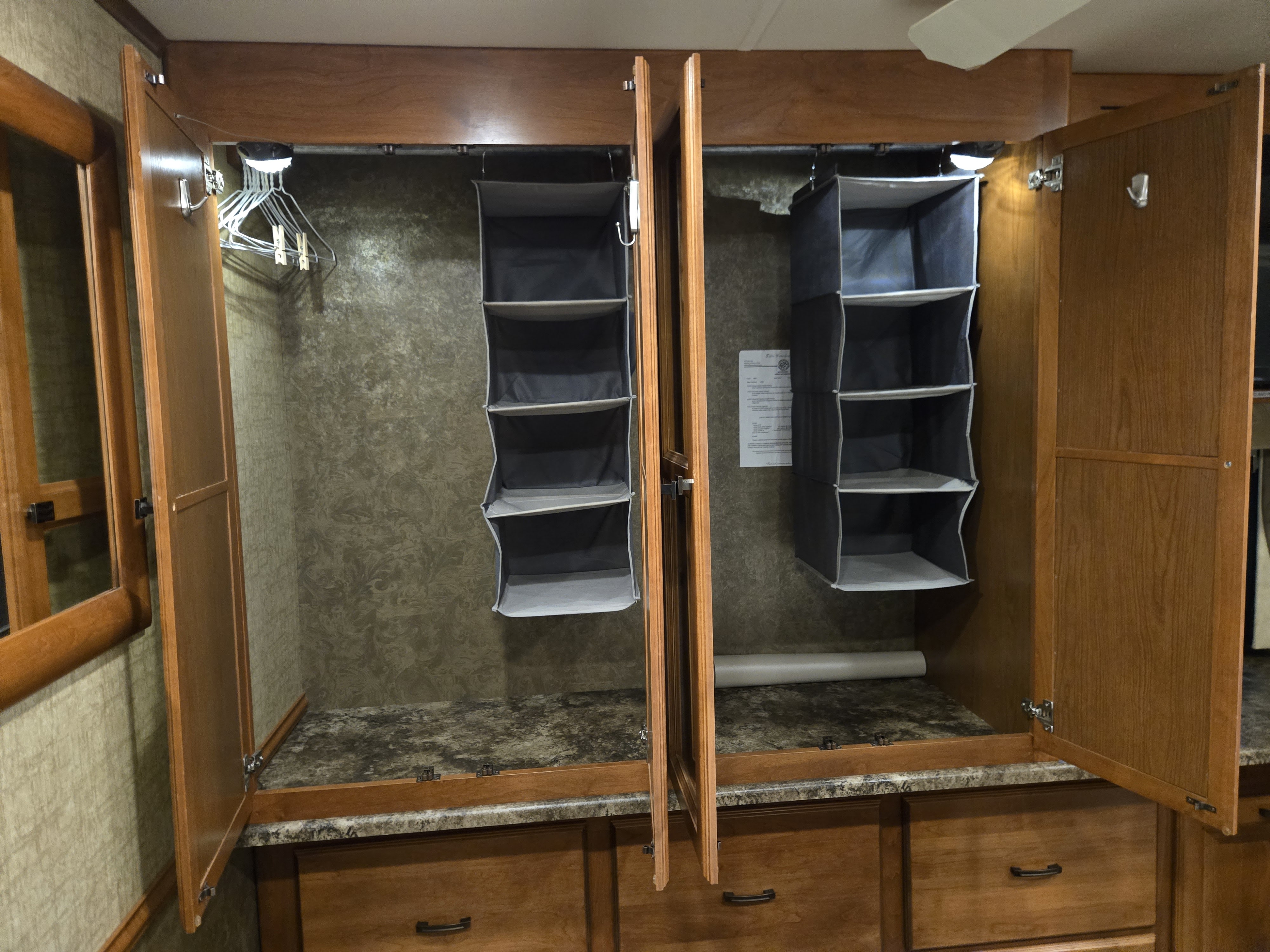 RV rental: spacious wardrobe with hanging organizers, hangers, and base drawers for travelers.. Allegro Allegro Motorhome 2014