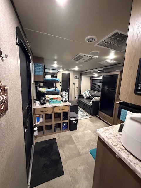 RV rental interior: bunk beds, coffee station, and cozy living area with a sofa. Ideal for travel adventures.. Grand Design Transcend Xplor 2020