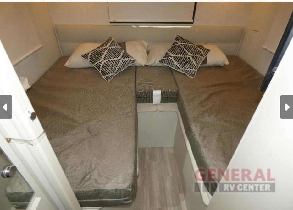 This rv rental features a cozy interior bedroom with two separate beds, ideal for comfortable travel accommodations.. Thor Motor Coach Vegas 2026