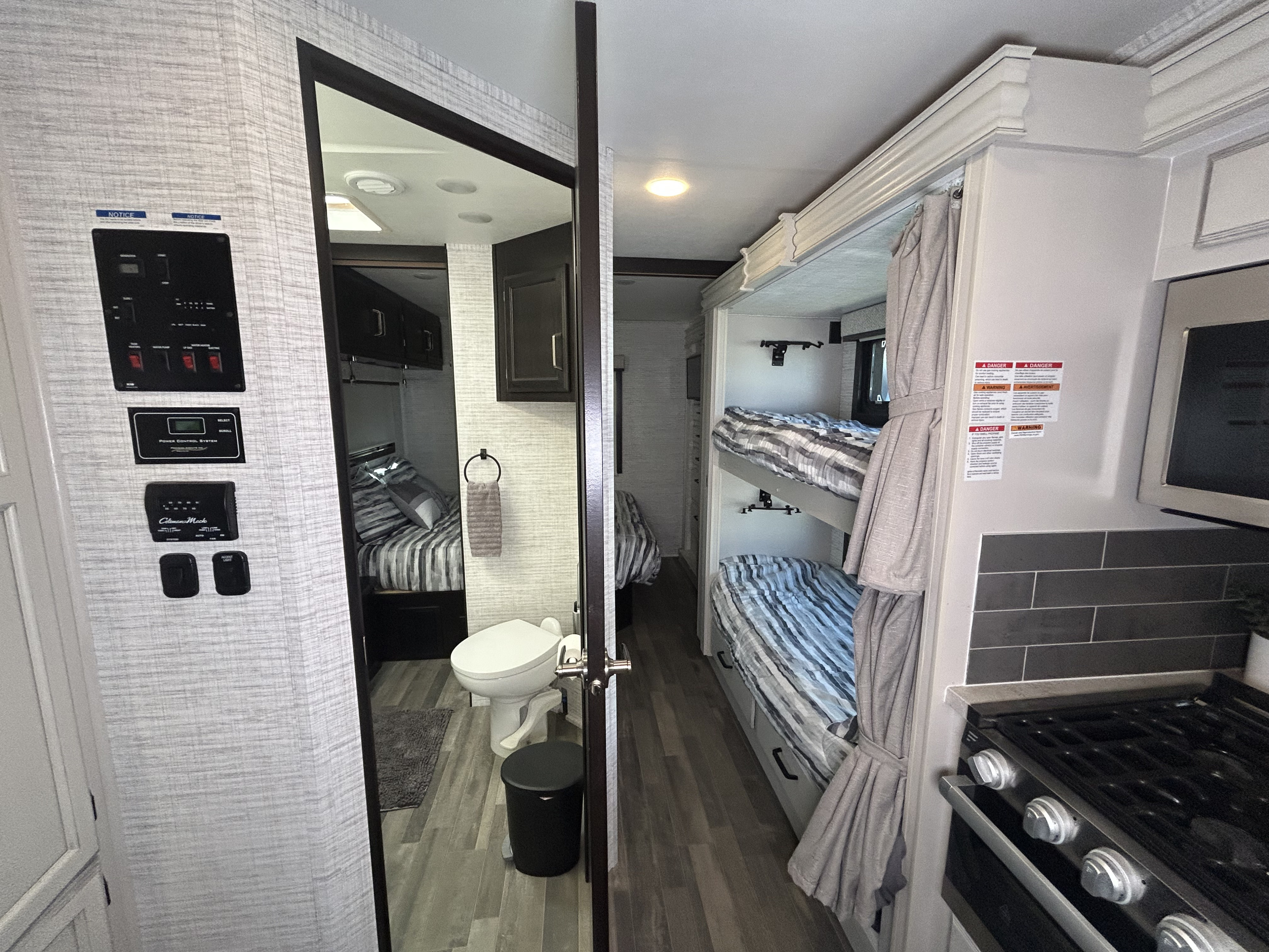 RV rental interior: control panel, bathroom, bunk beds, and kitchen view. Comfortable and functional for your travels.. Jayco Alante 2024