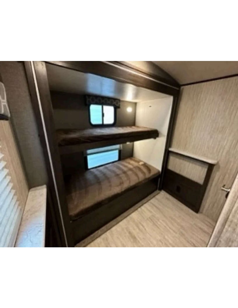 RV rental bunk beds: A cozy sleeping area with windows and comfortable mattresses inside a camper.. Shadow Trailers 289 RBS 2018
