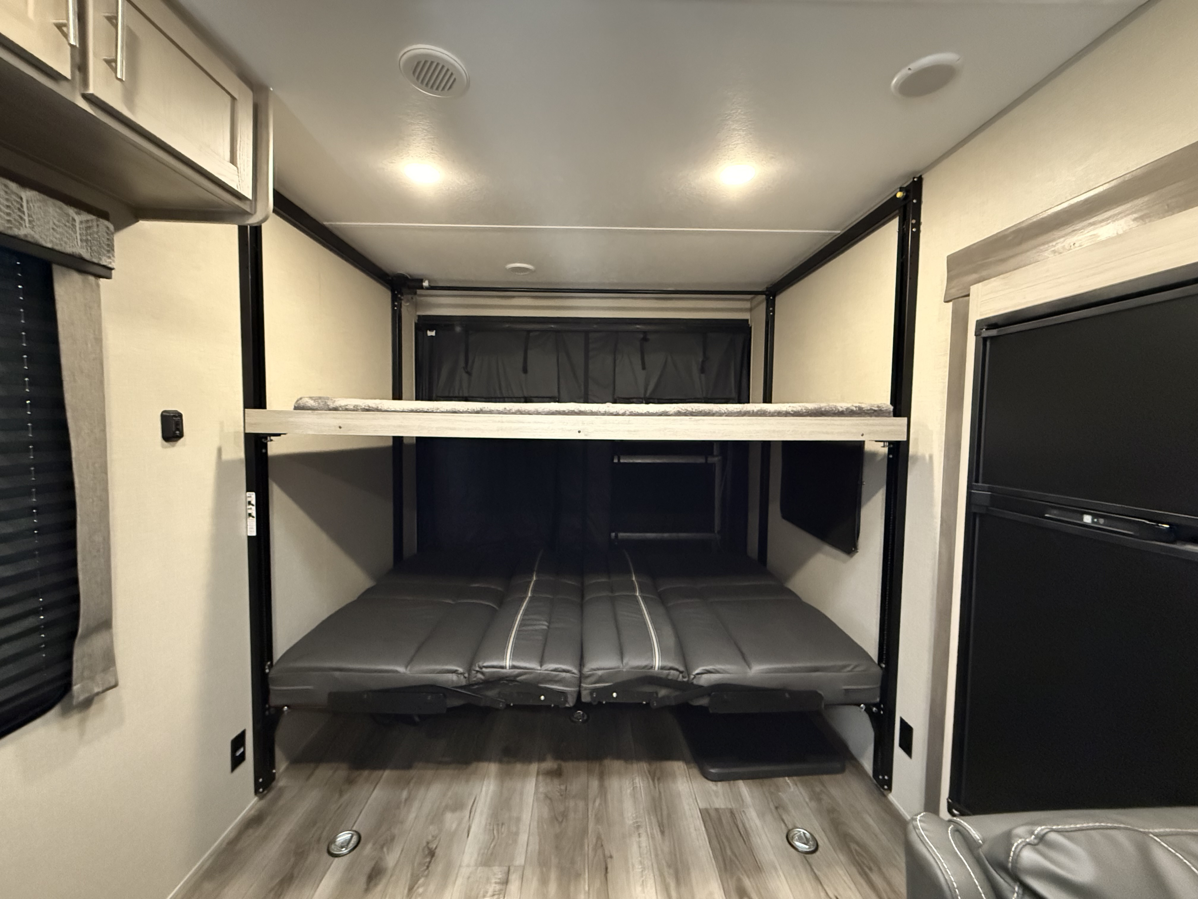 Experience this **rv rental's** versatile interior with convertible bunk beds and a refrigerator, offering flexible sleeping for travel.. Coachmen Catalina 2022
