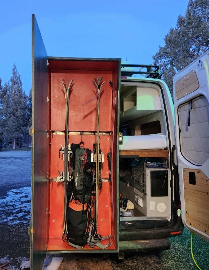 Custom RV rental setup for winter adventures: ski storage, cozy bed, and organized gear space in a camper van.. Mercedes-Benz Sprinter 2020