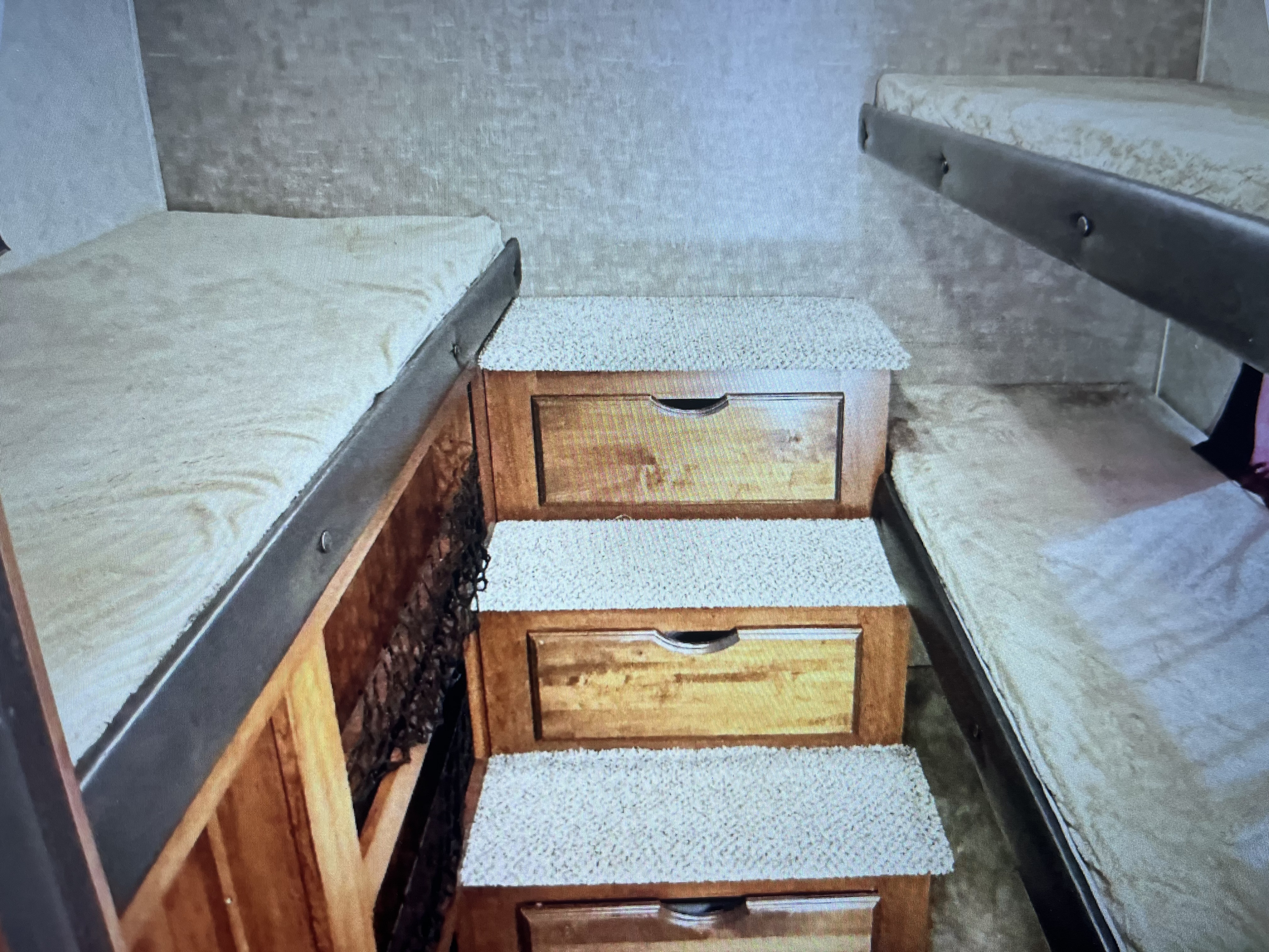 RV rental bunk beds with clever storage steps and drawers, optimizing space in this compact bedroom area.. Jayco Eagle HT 2017