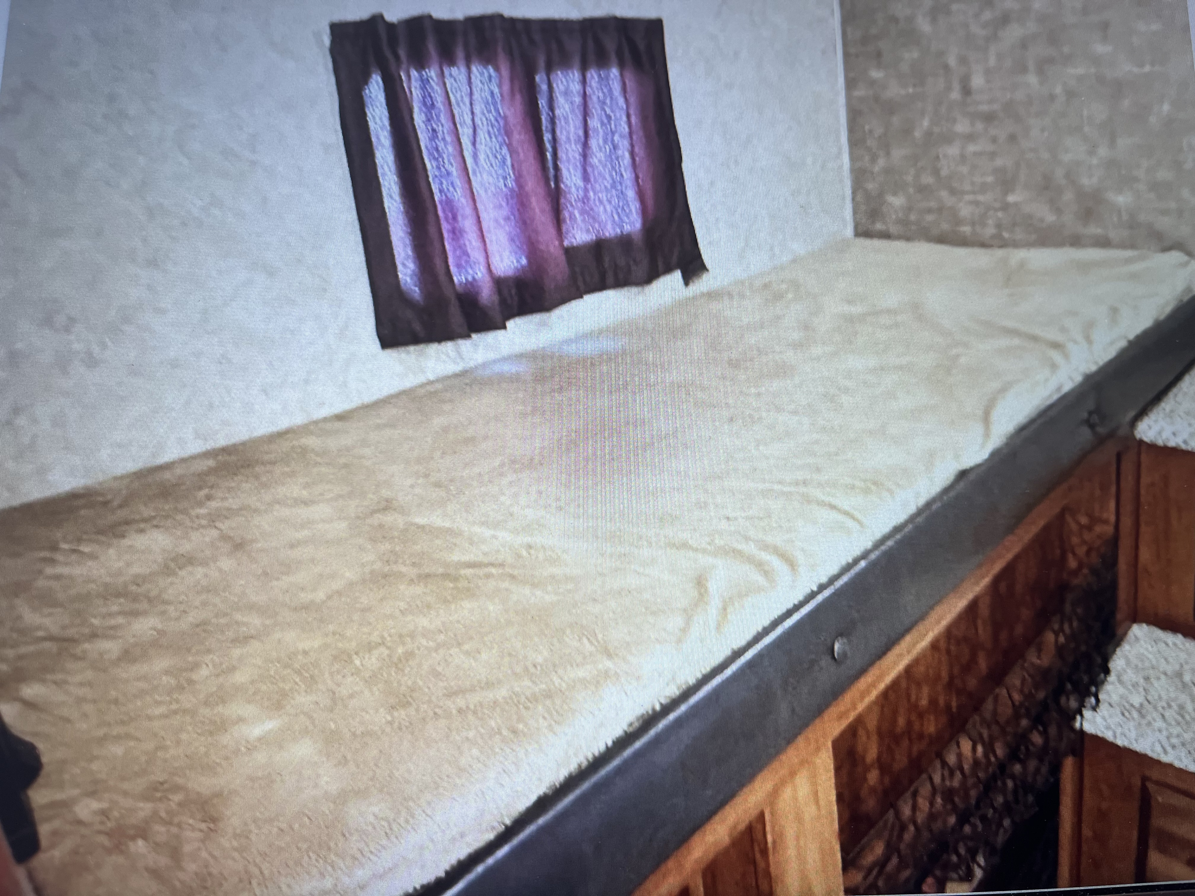 Cozy RV rental bunk bed area with a soft blanket, featuring a window with purple curtains for a comfortable sleep.. Jayco Eagle HT 2017