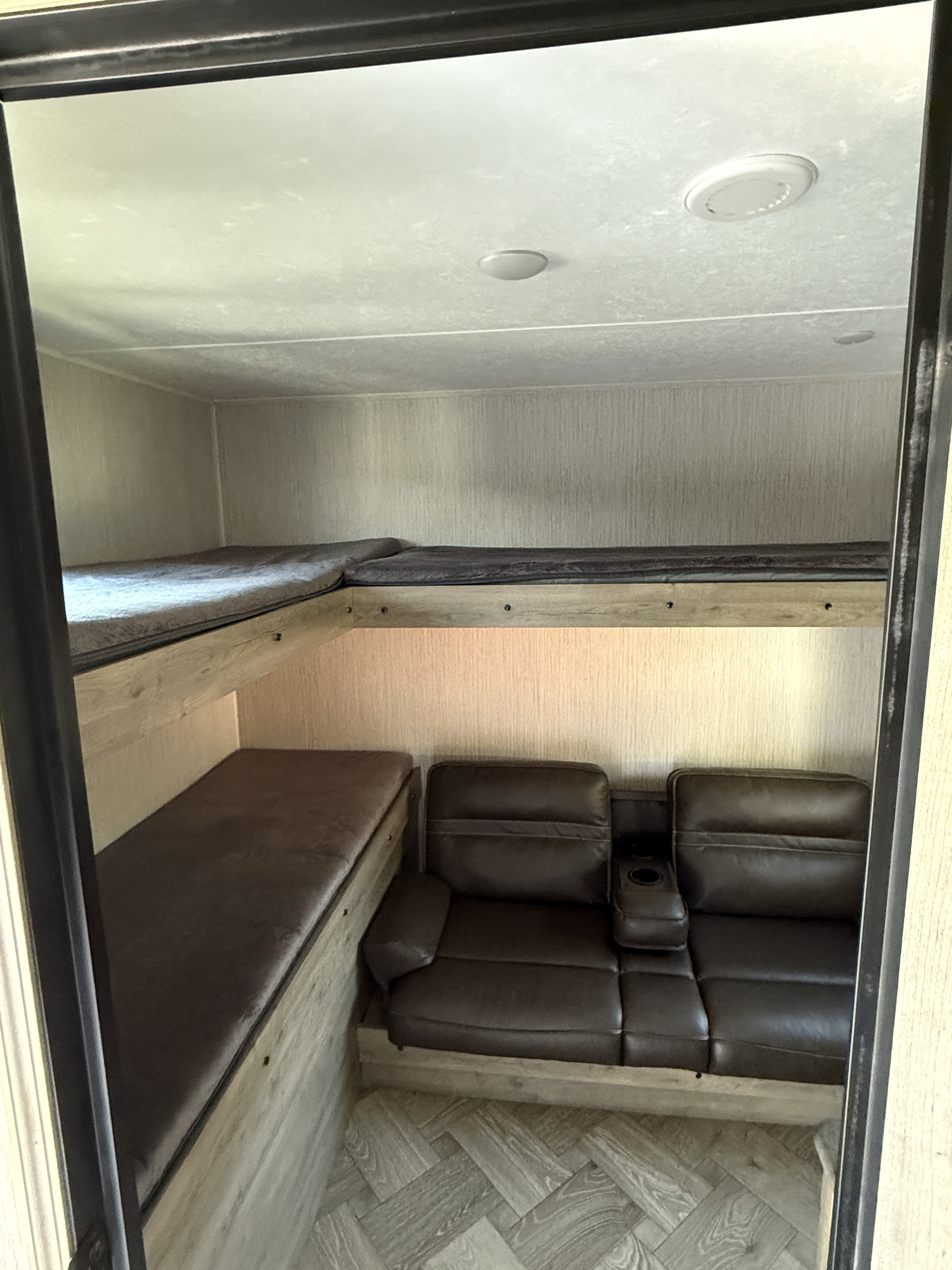 RV rental bunkhouse: two bunks, plus a comfy brown reclining sofa. Perfect for family trips.. Palomino Puma 2022