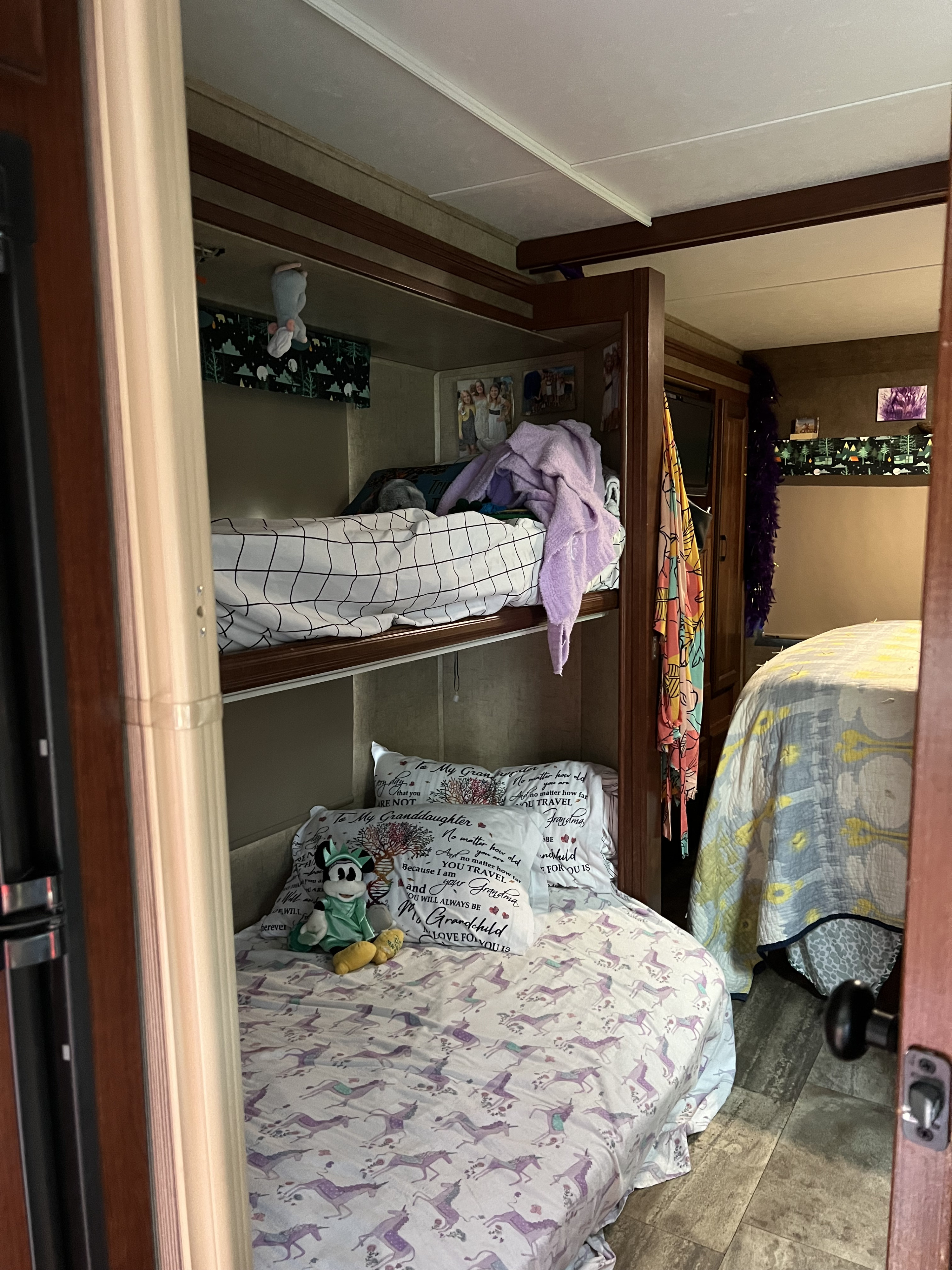 An RV rental's cozy bunk beds and queen bed, making travel comfortable for all your family adventures.. Forest River Sunseeker LE 2017