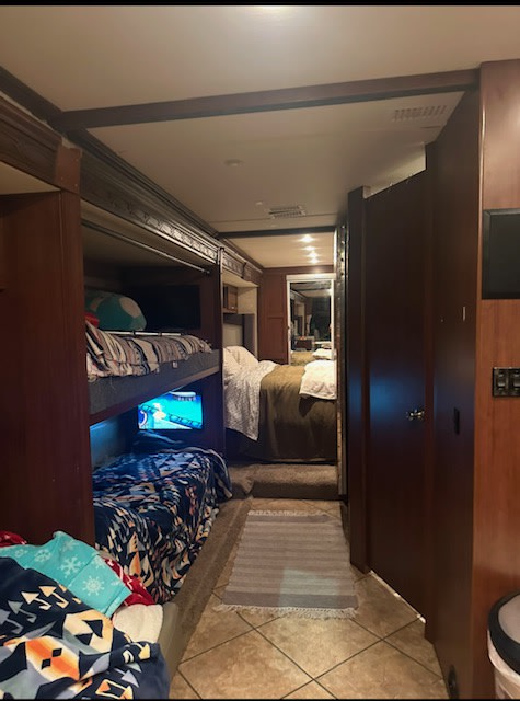Inside an RV rental: cozy bunk beds, a narrow hallway leading to a comfy master bedroom.. Fleetwood expedition 2011