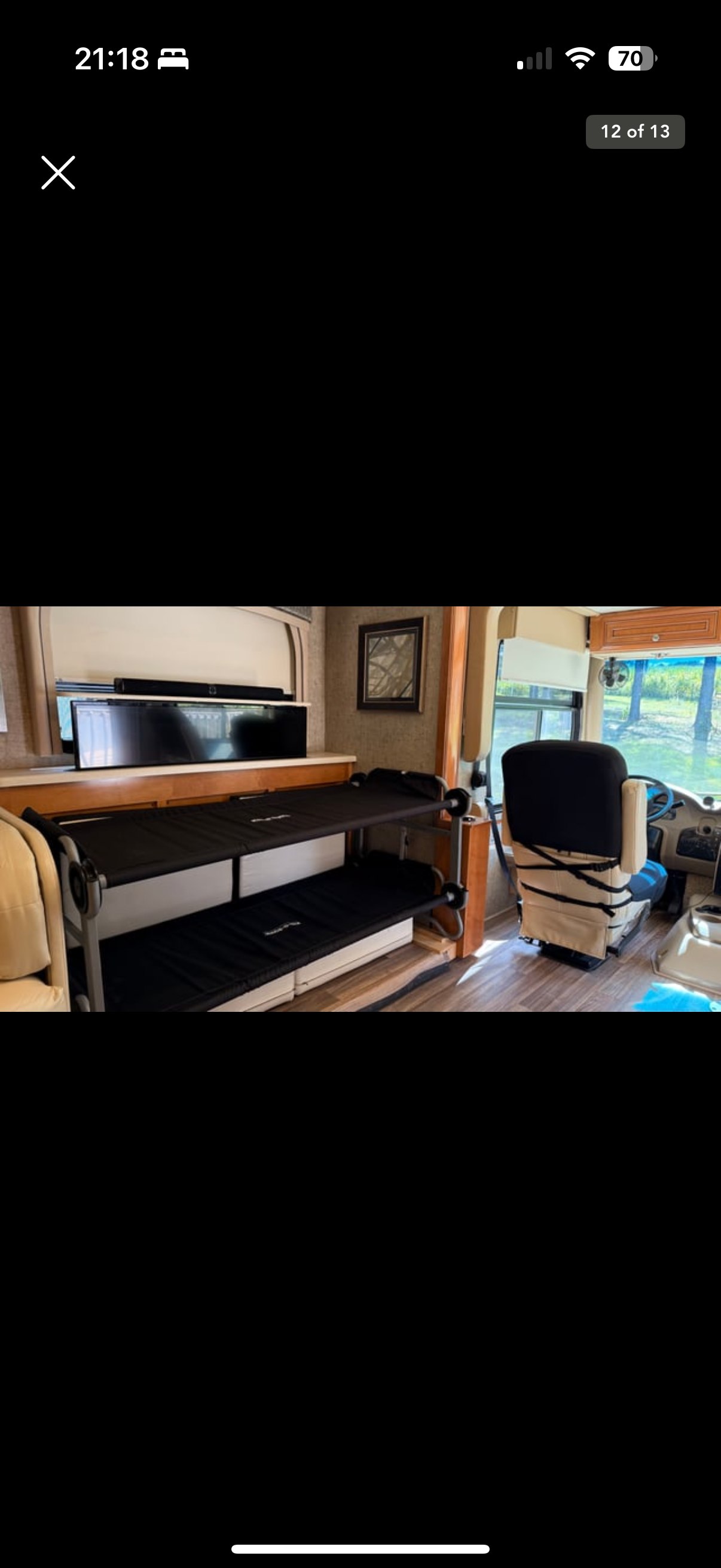 RV rental interior: comfy bunk beds, TV, and driver's area shown. Perfect for family adventures.. Thor Miramar 2017