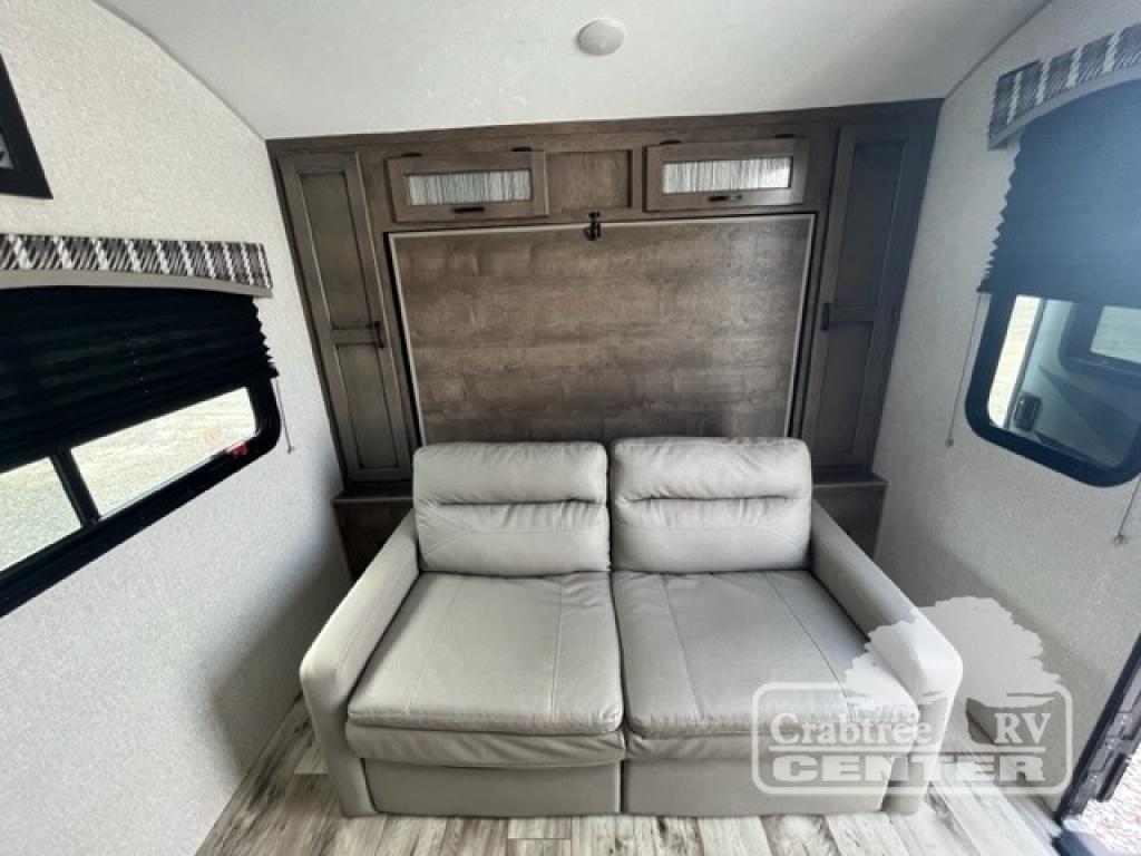 Inside this RV rental: a plush sofa and space-saving murphy bed, perfect for a versatile living area.. Venture Sonic 190VRB 2022