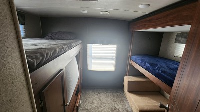 RV rental: Cozy bunk room interior with two bunk beds, a window, and carpeted floor for comfortable sleeping.. Heartland RVs Mallard 2018
