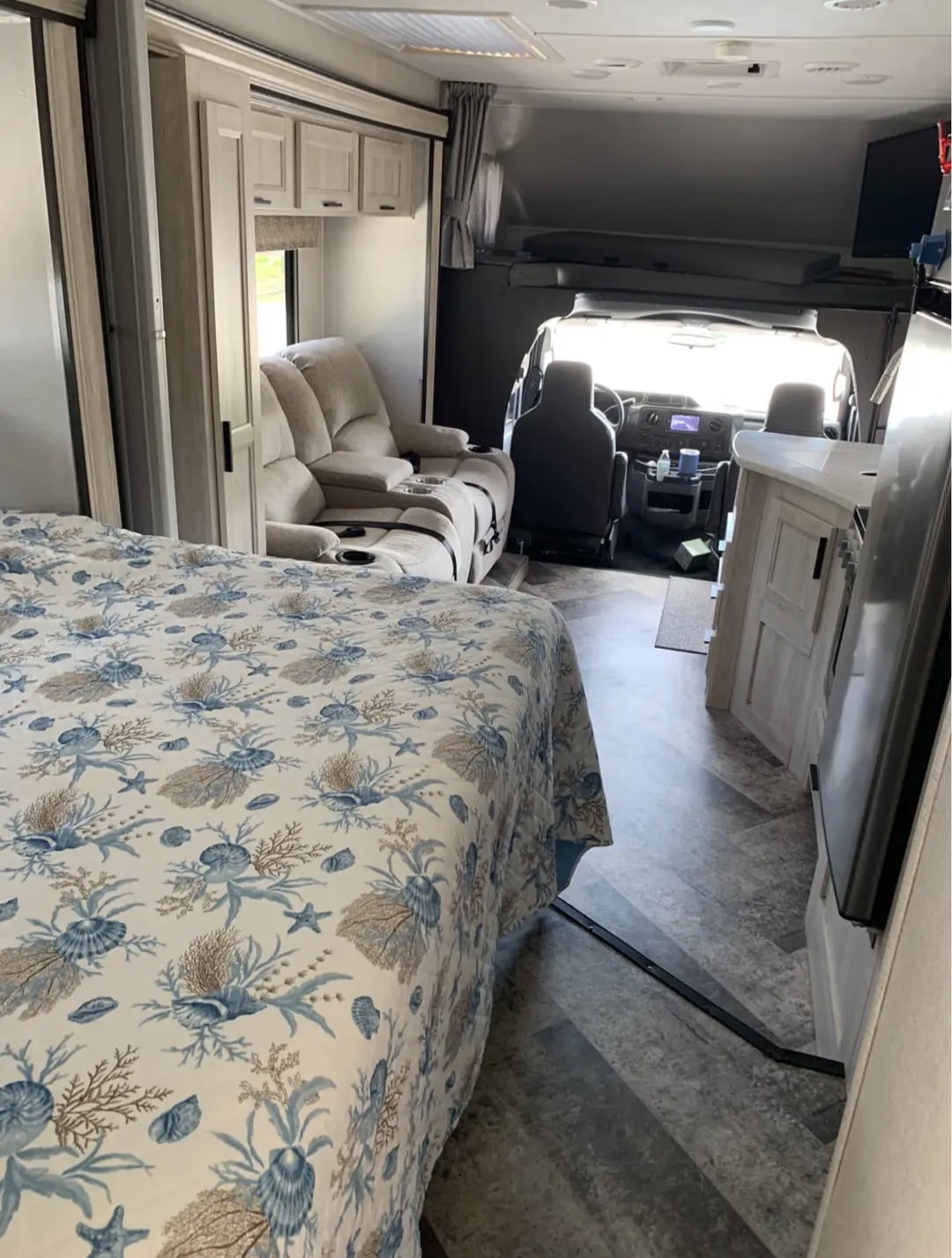 RV rental interior shows a bedroom with marine-themed bedding, a recliner living area, and the driver's cabin ahead.. Forester Forester Motorhome 2020