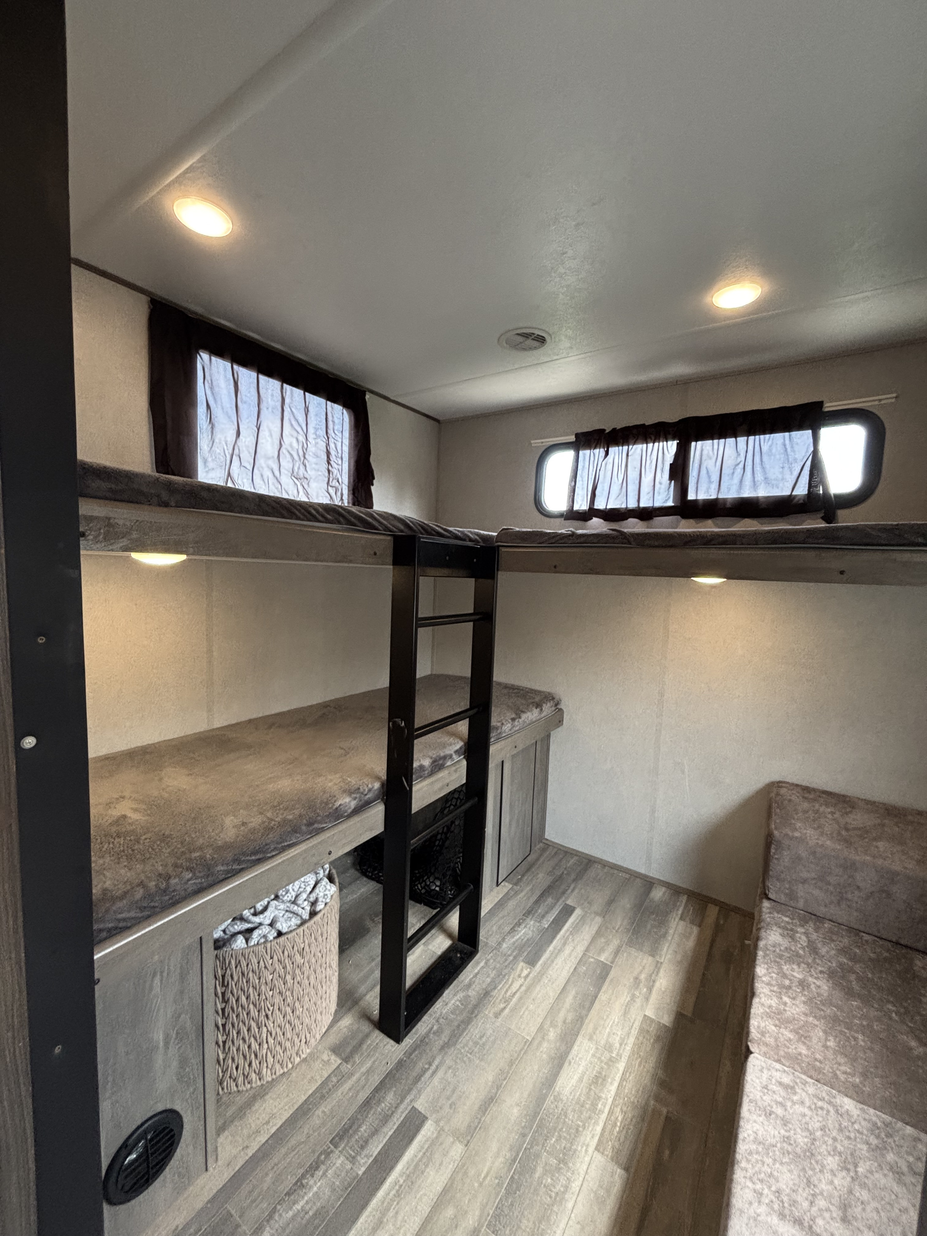 Cozy RV rental bunkhouse with comfy bunk beds, ladder, windows, and storage for a family adventure.. Forest River Vibe 2021