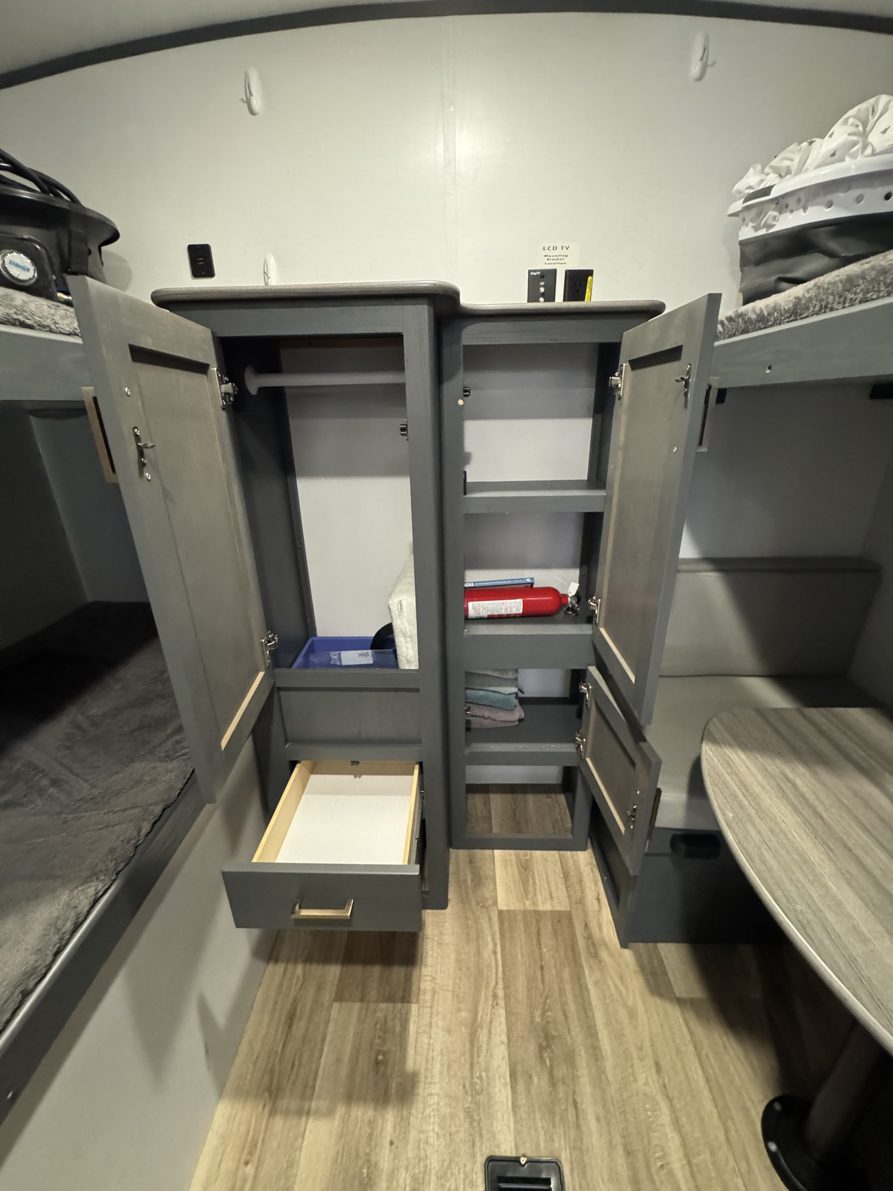 RV rental interior: cozy bunk beds, ample storage with a fire extinguisher, and a dinette table. Perfect for family travel.. Keystone RV Bullet Ultra Lite 2022