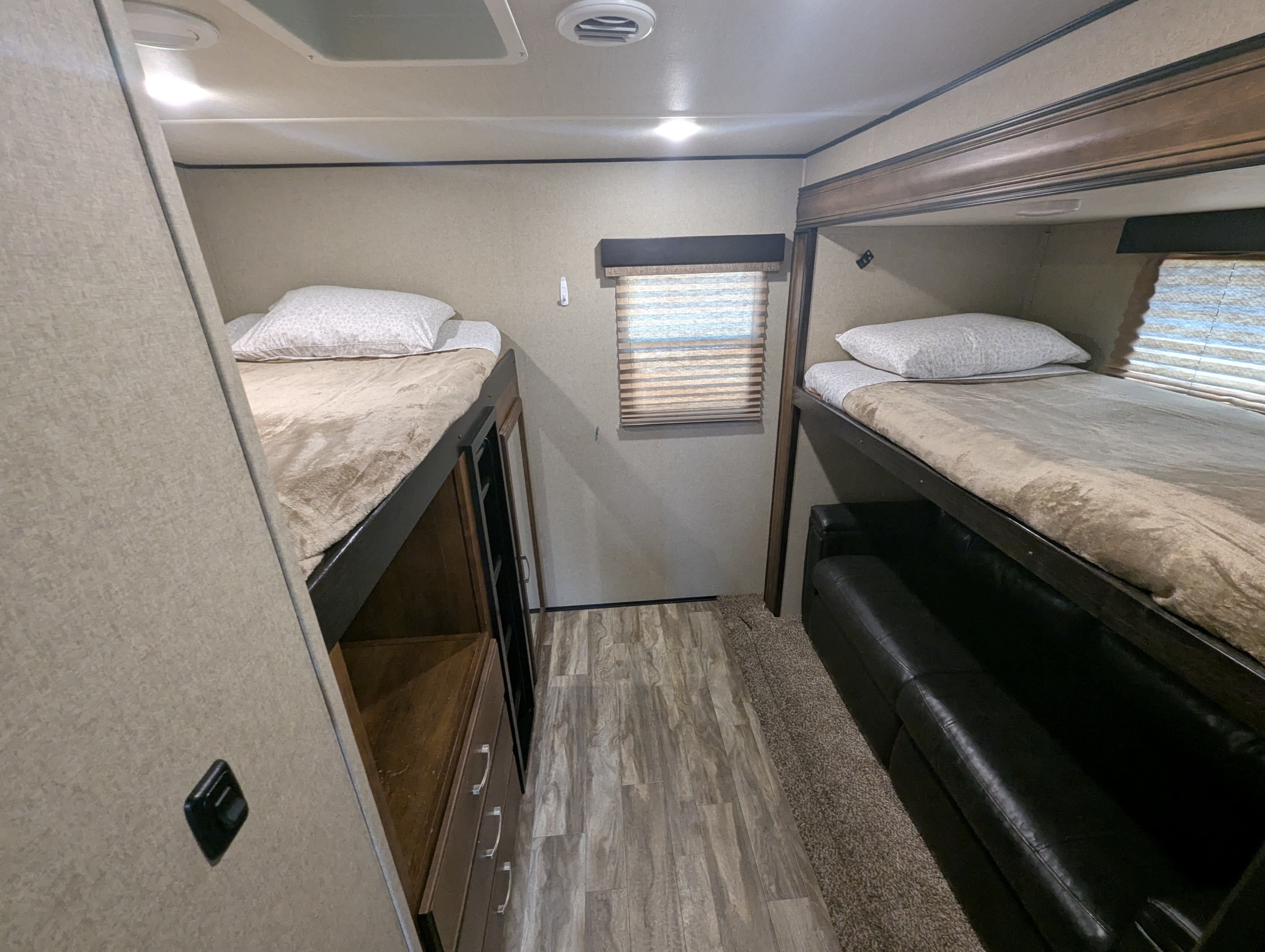 RV rental interior: a comfortable bunkhouse with beds on each side, one over storage, the other over a couch.. Grand Design Reflection 2019