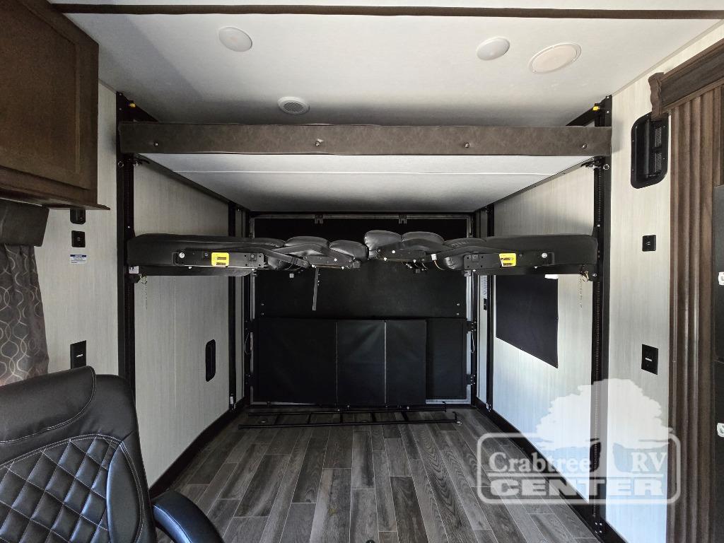 This RV rental's toy hauler garage features a raised bunk bed and a lower convertible sofa for versatile living space.. Cherokee Wolf Pack 2020