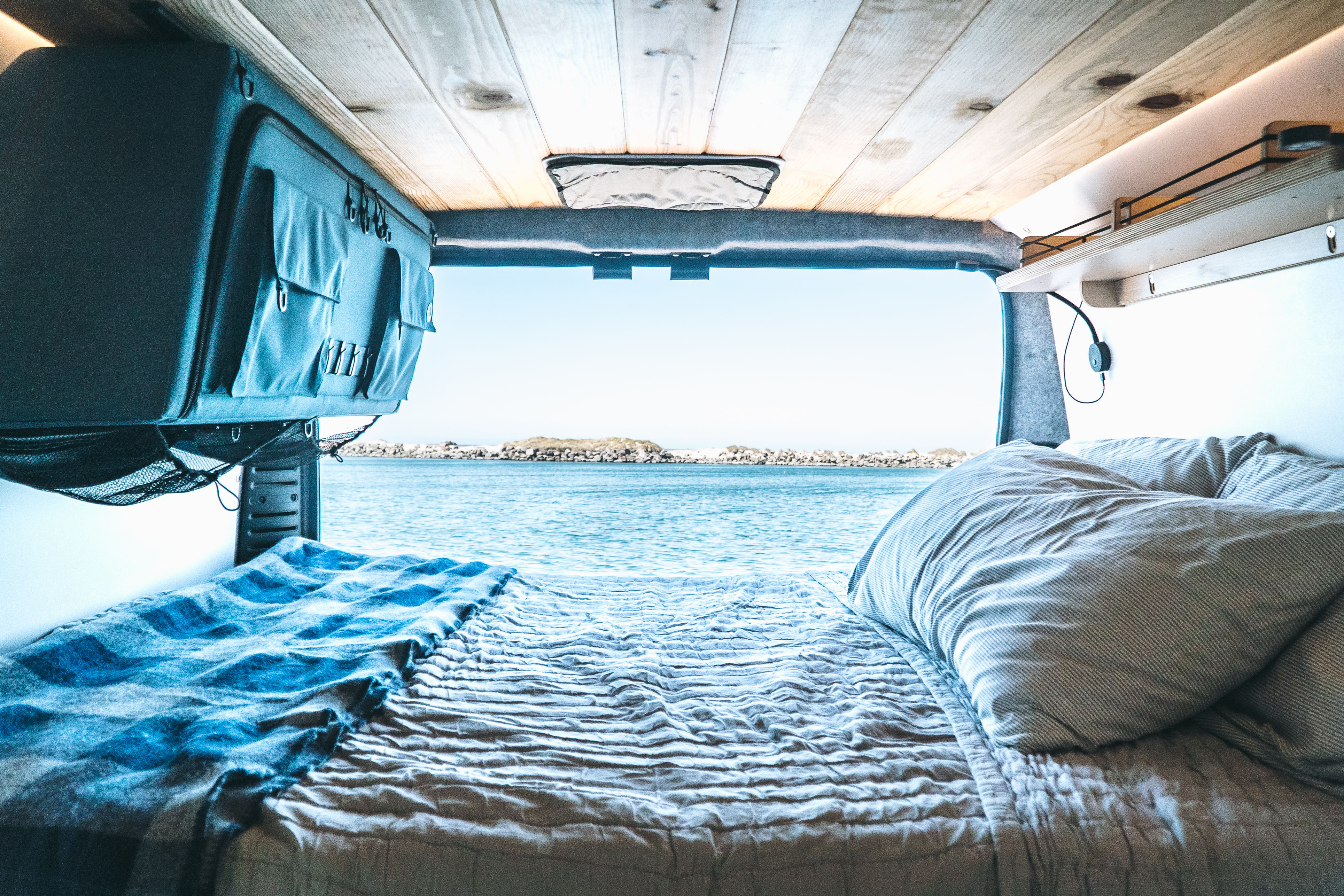 Enjoy the stunning ocean view from your cozy RV rental bed! Perfect for van life adventures by the sea.. Dave & Matt Vans Dave & Matt Vans Class B 2022