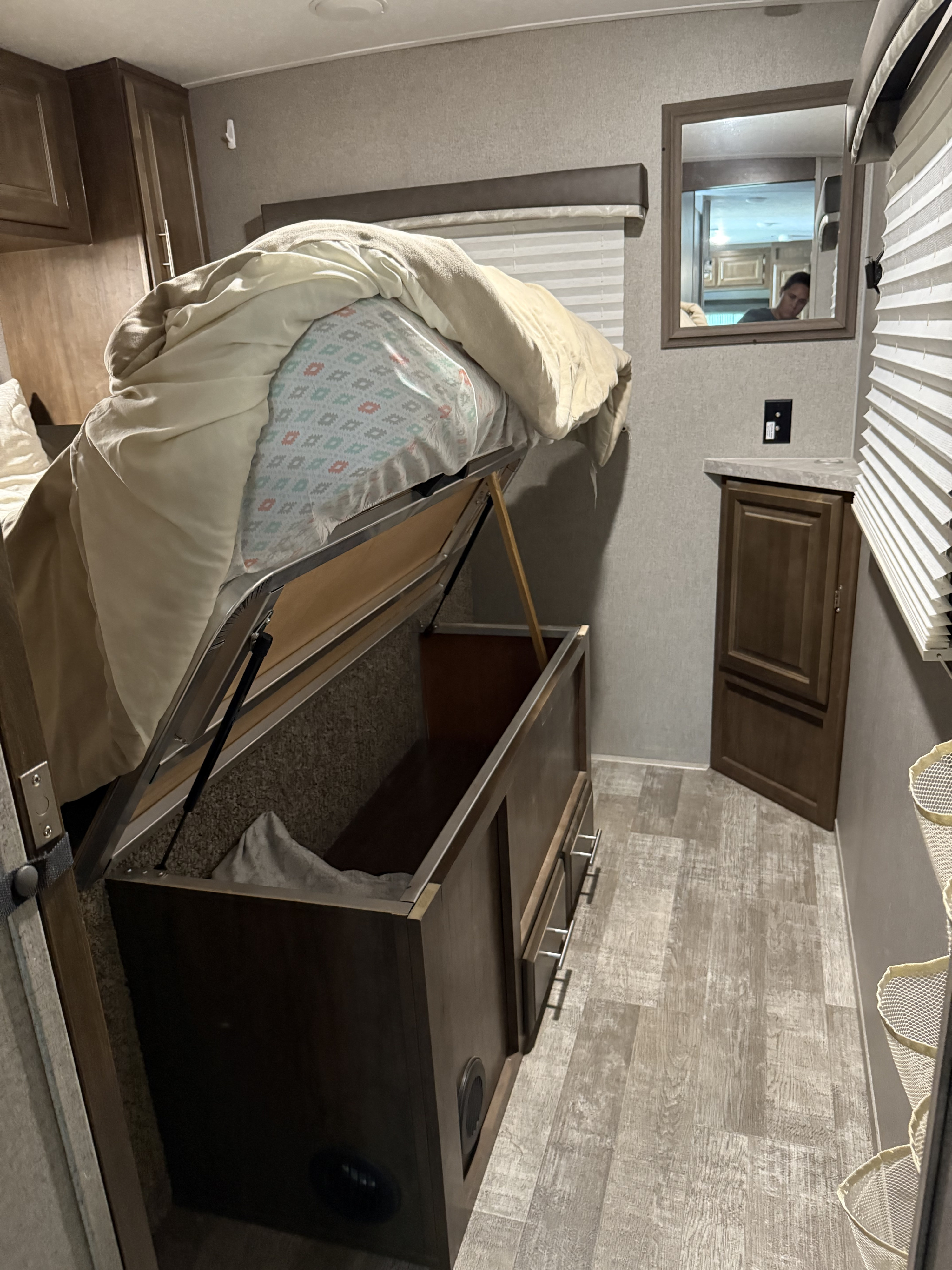Smart RV rental bed with lift-up storage and built-in cabinets, maximizing space in this compact interior.. Forest River Rockwood Mini Lite 2020