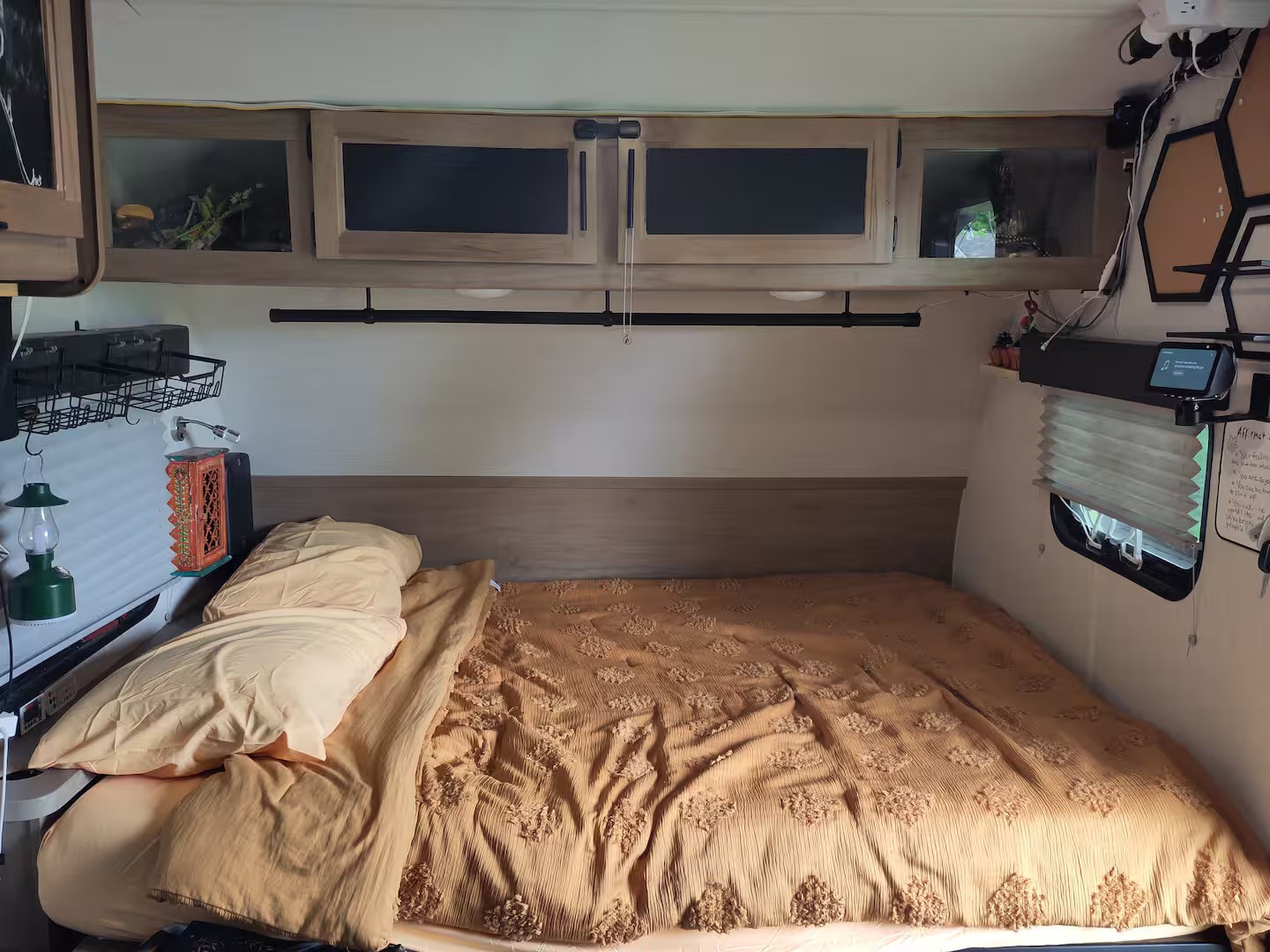 This RV rental bedroom features a cozy bed, overhead storage, and smart devices for a comfortable stay.. Forest River Cherokee Wolf Pup Black Label 2023