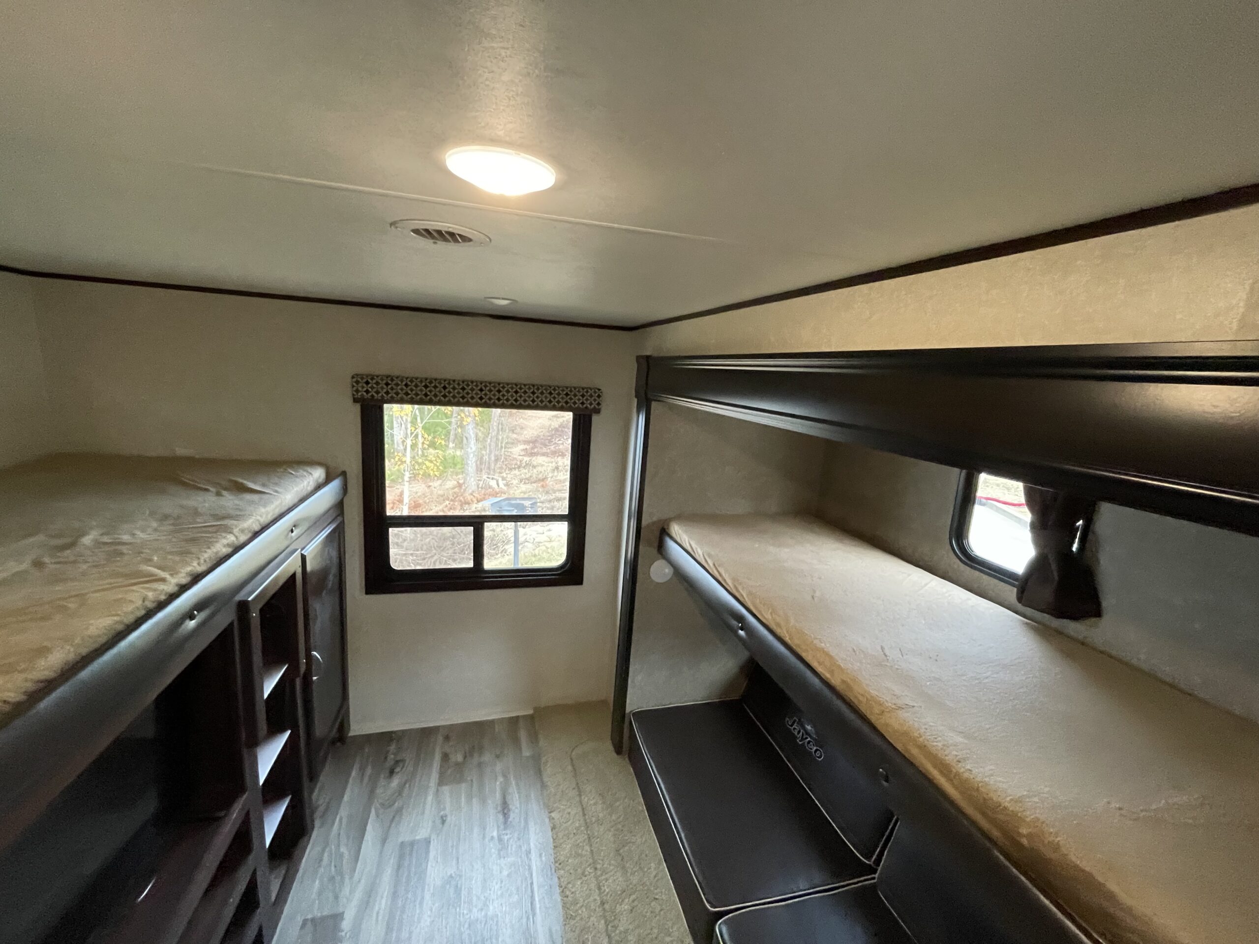 Spacious Jayco RV rental bunkhouse with multiple beds, storage, and a scenic window.. Jayco Jayflight 2018