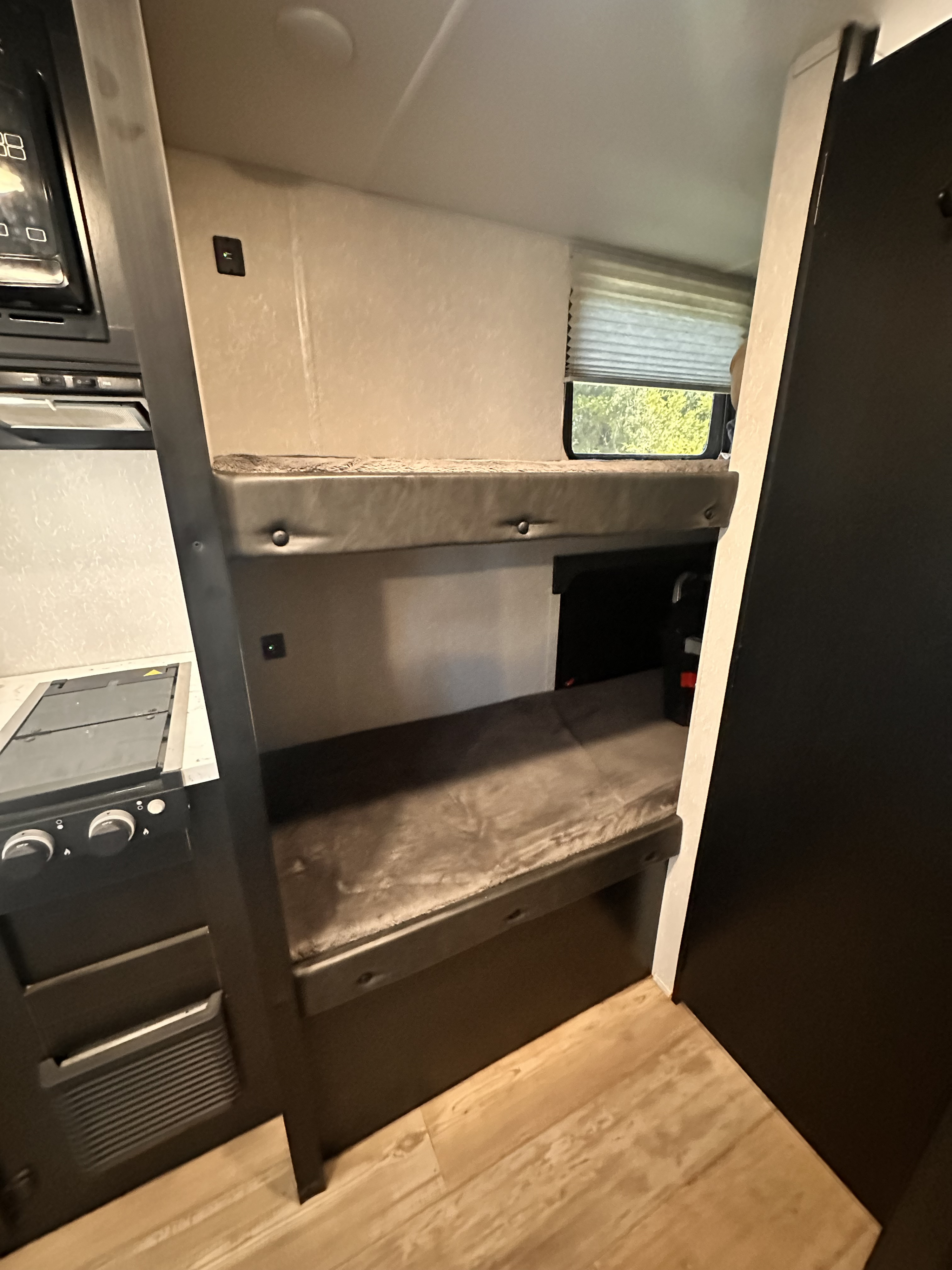 This RV rental offers a compact interior with stacked bunk beds, a kitchenette, and convenient charging ports for your journey.. Forest River Cherokee Wolf Pup 2021