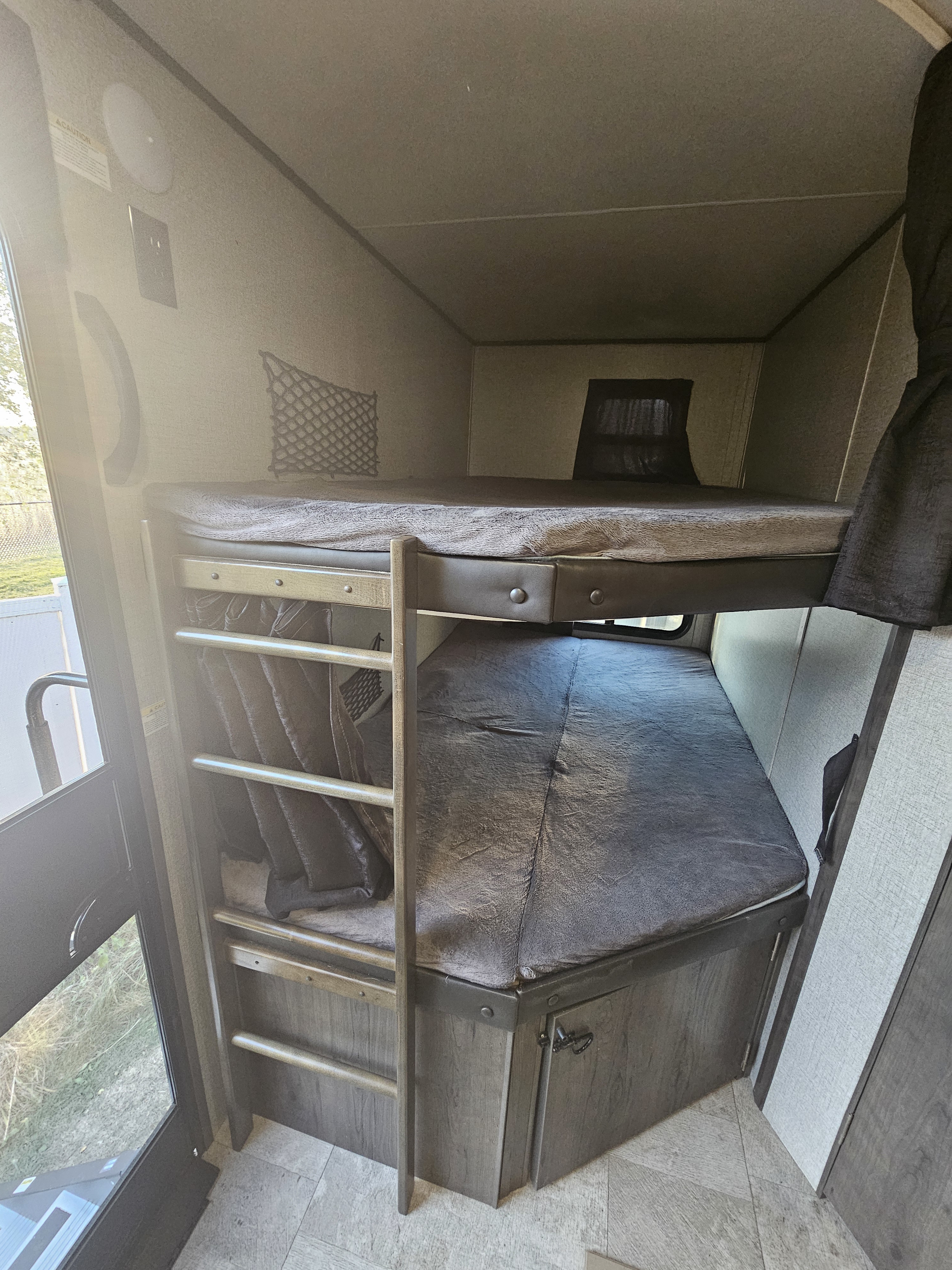 Inside an RV rental: view of comfortable bunk beds, a ladder, and storage. Ideal sleeping quarters for travelers.. Jayco Jay Flight 2020