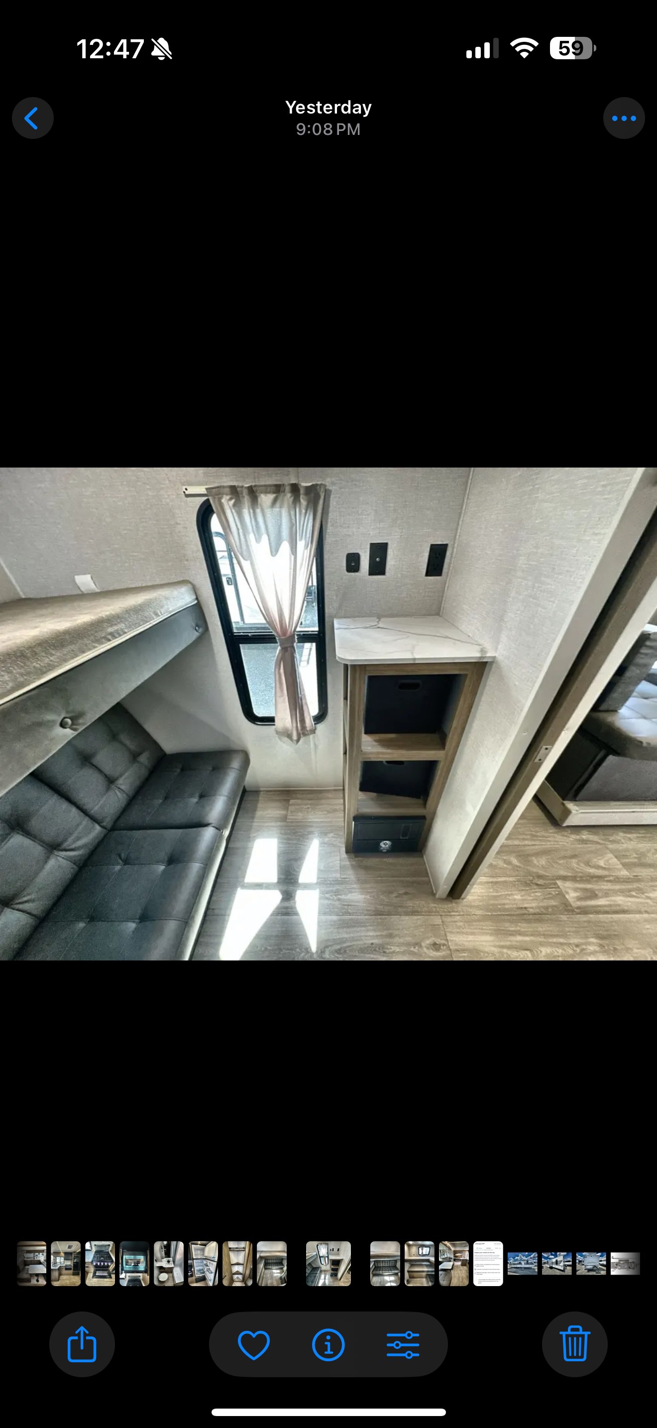 Inside an RV rental: bunk beds over a futon sofa, a window, and handy storage shelves. Bright, modern interior for your trip.. Forest River Wildwood X-Lite 2026